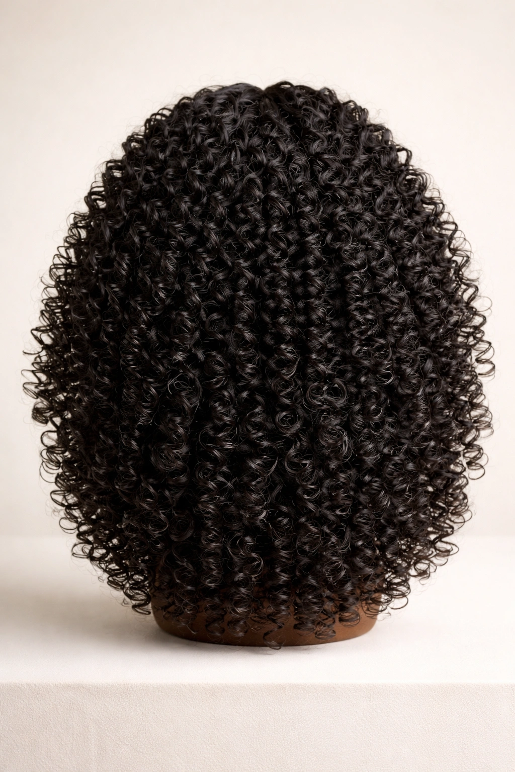 Close-up of a bouncy coil texture wig showing tight coils and natural volume