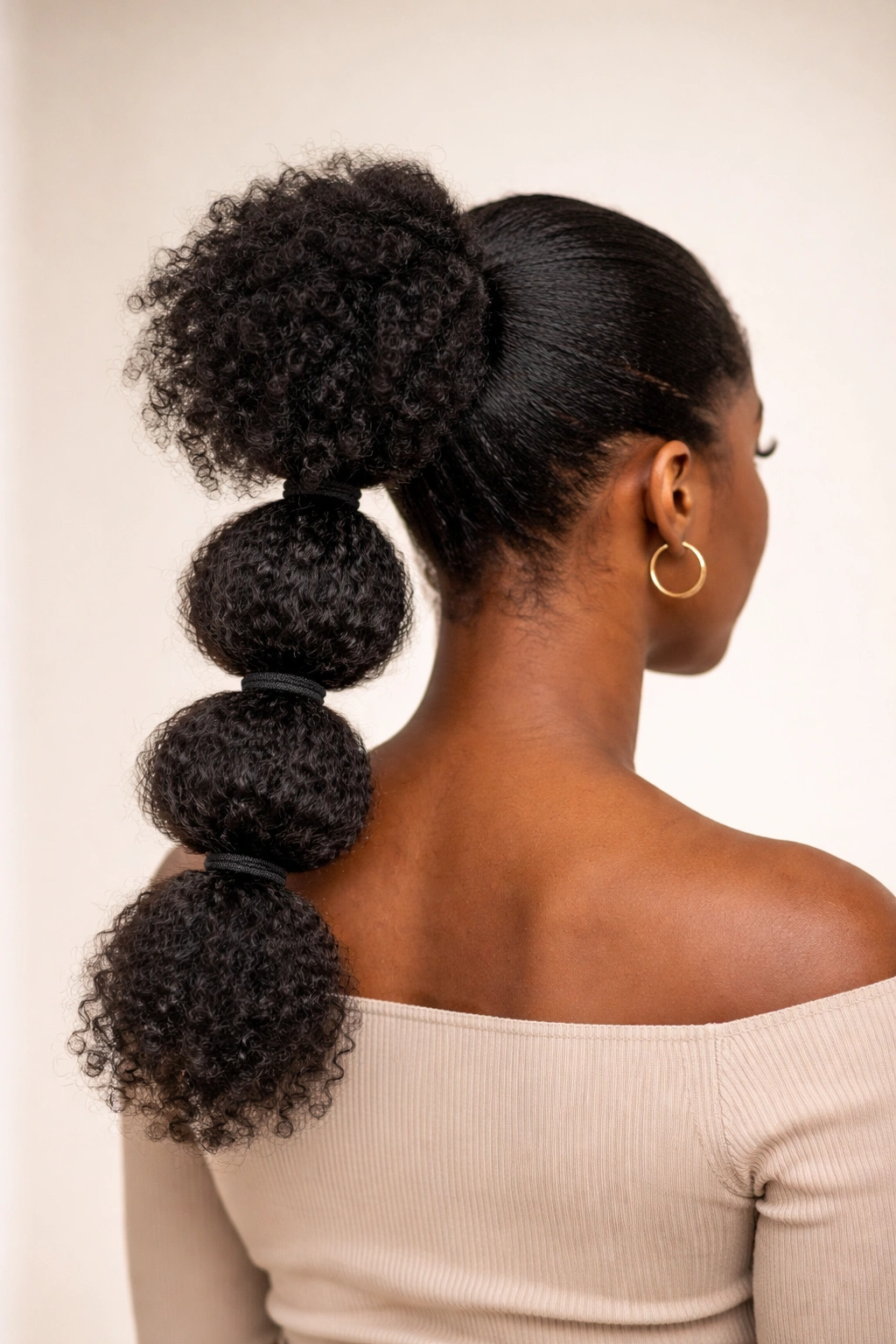 Back view of a bubble puff ponytail showing multiple elastic-separated bubbles