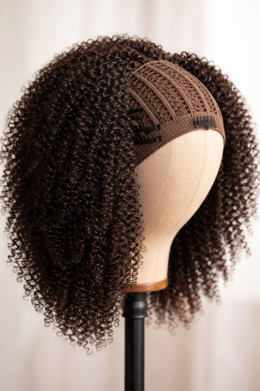 Close-up of crochet wig on head form showing cap construction and textured hair