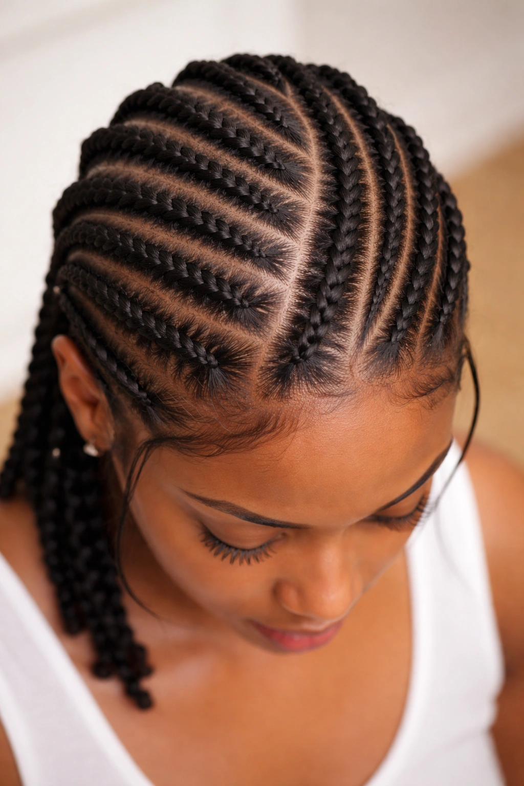 Geometric flat twists pattern visible against the scalp