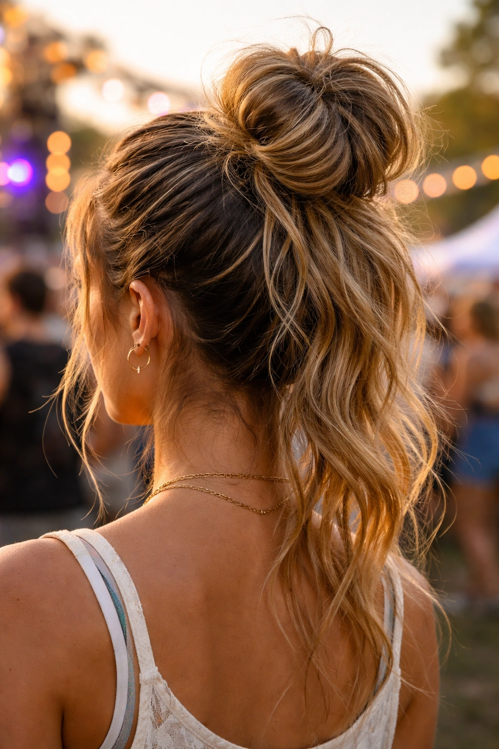 Close-up of a high pony bun with textured, loose ends for festival hair