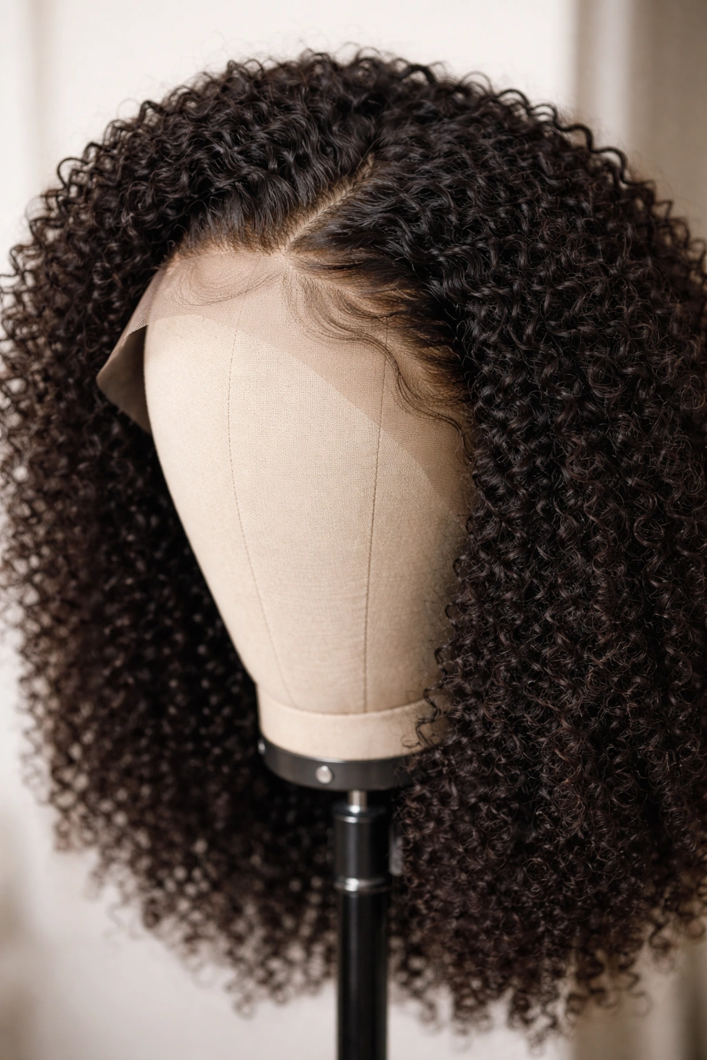 Kinky-curly lace-front wig with customizable edges on display