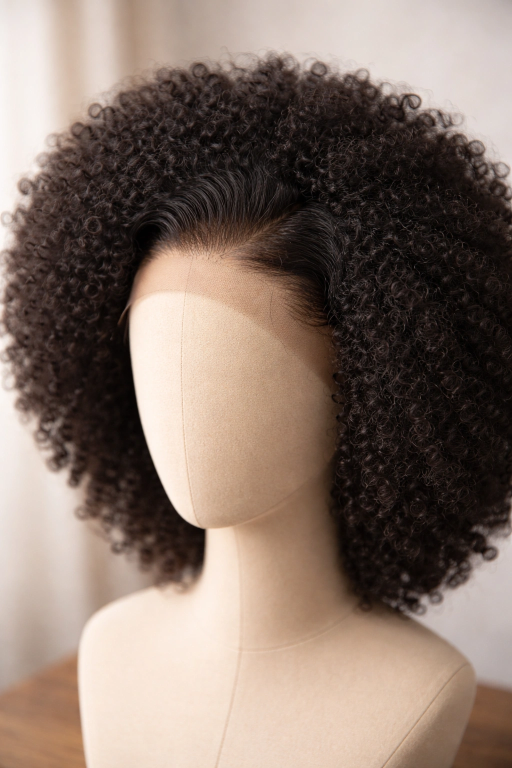 Lace-front afro wig with visible hairline on a mannequin head