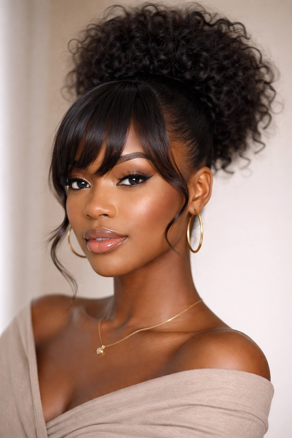 High puff ponytail with curved bangs on a Black woman, voluminous crown