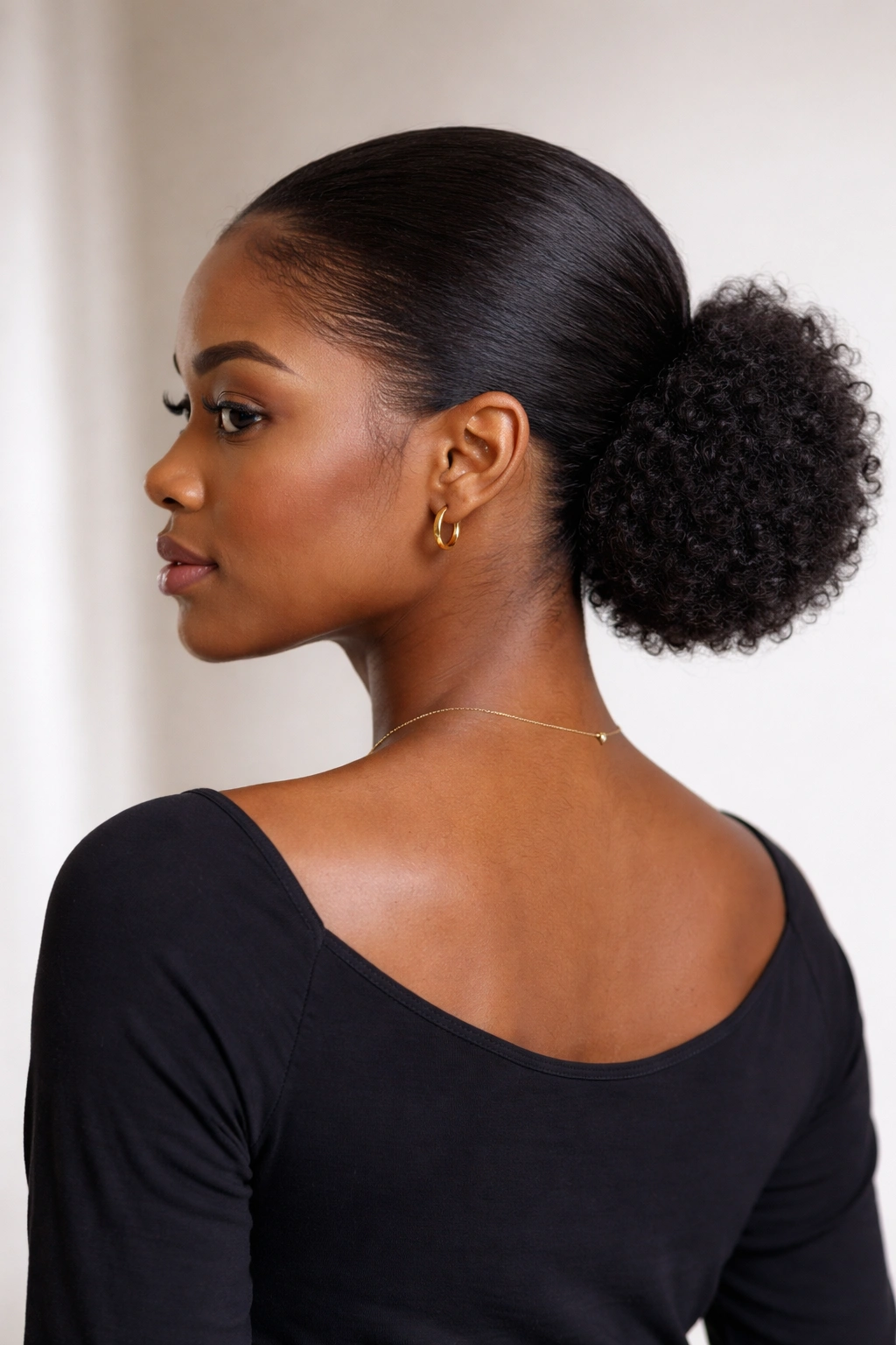 Back view of sleek low puff at nape highlighting elongation