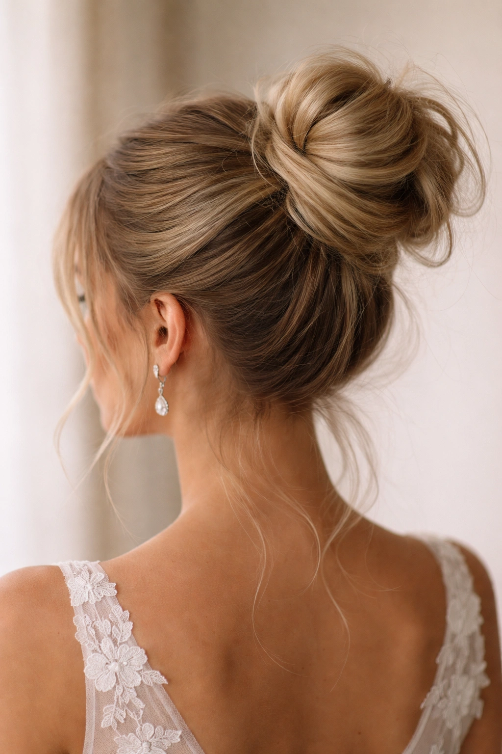 Rear three-quarter view of a sleek wrapped base messy bun.