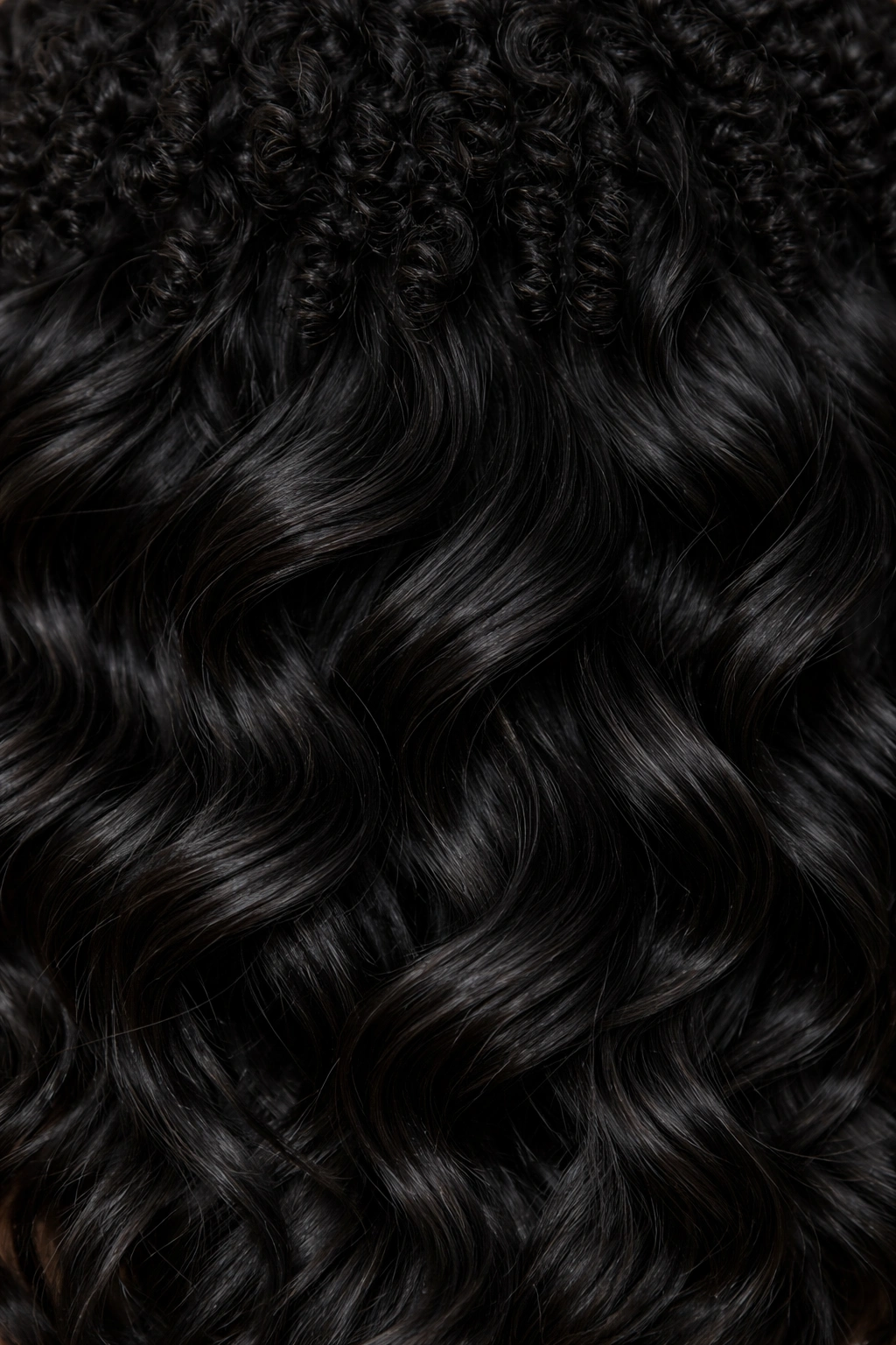 Close-up of soft coils with wave pattern in textured Black hair