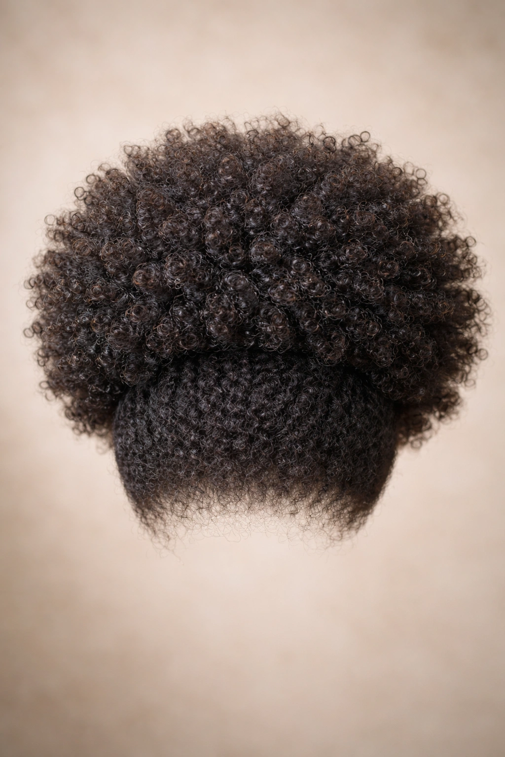 Textured puff afro wig with defined crown and tapered sides on neutral backdrop