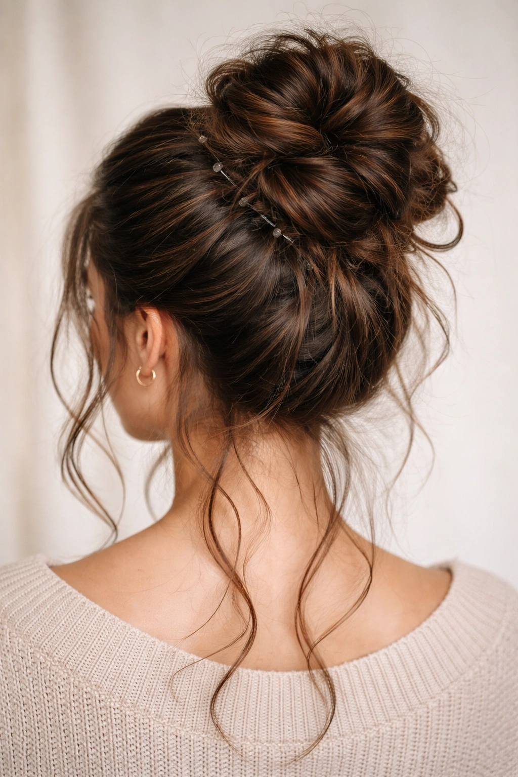 Portrait showing thick hair secured with multiple anchor points around a bun, emphasizing distribution.