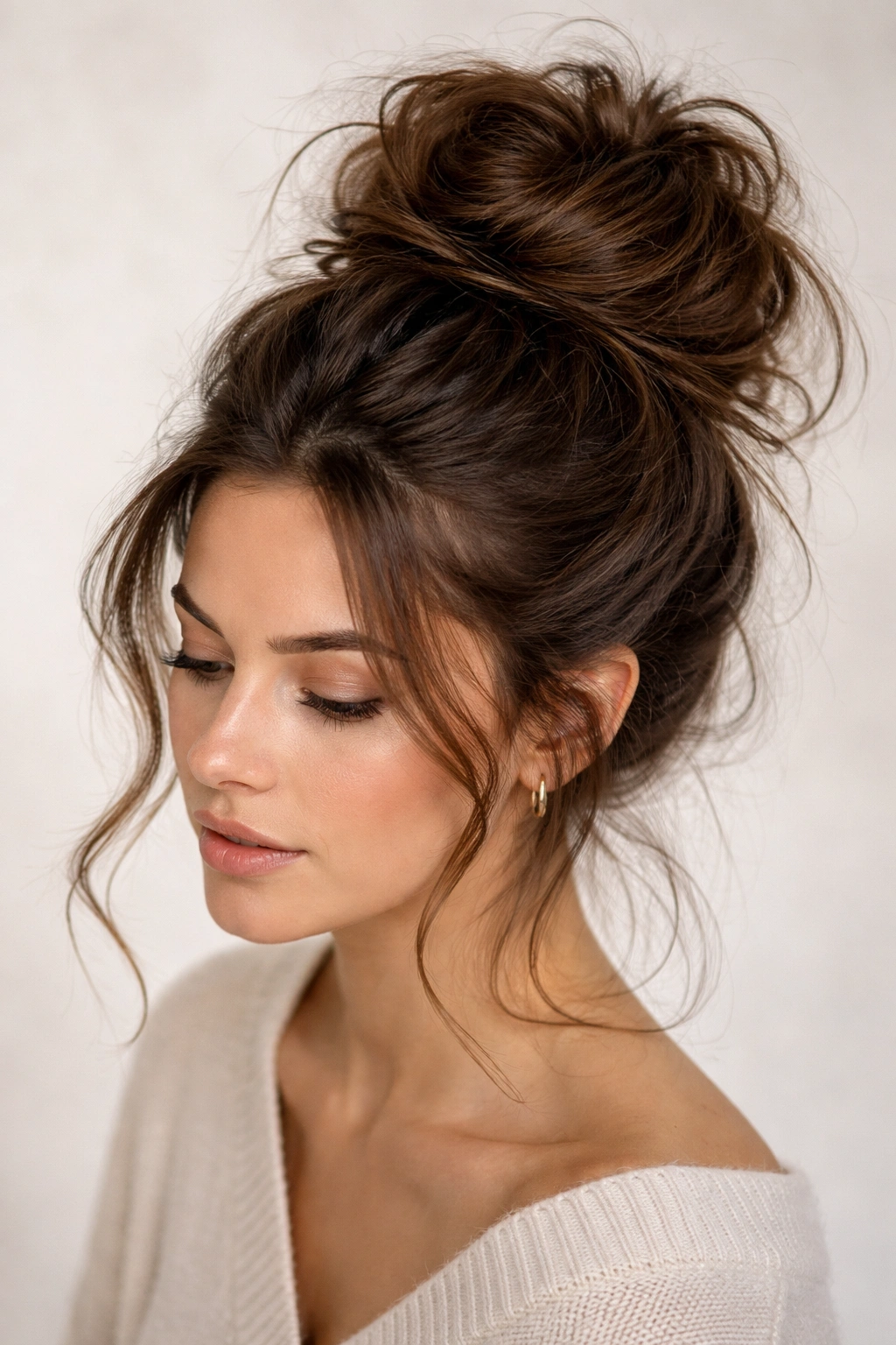 Tousled high bun at the crown with loose strands