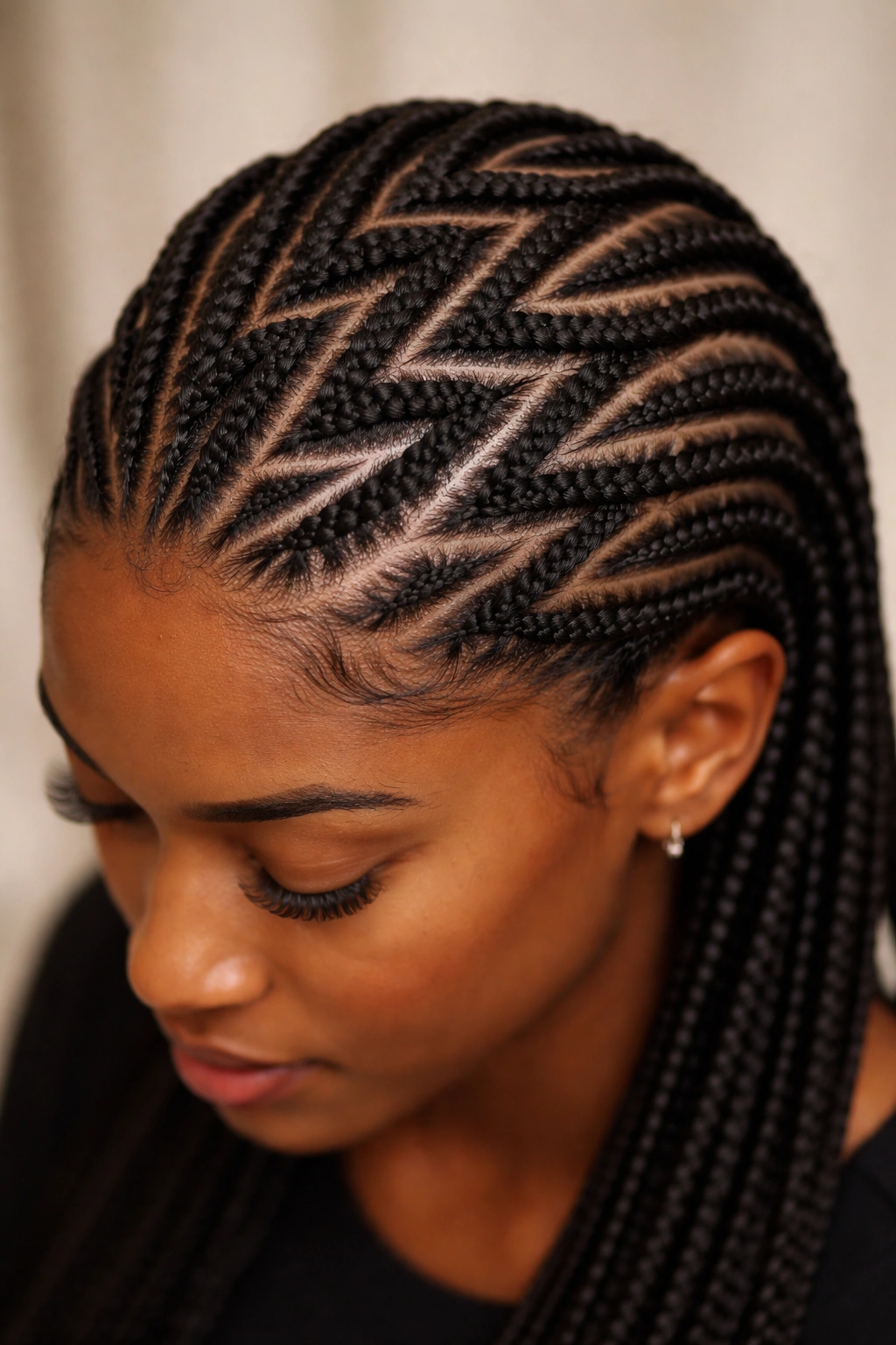 Close-up of zig-zag cornrows on scalp showing geometric protective hairstyle