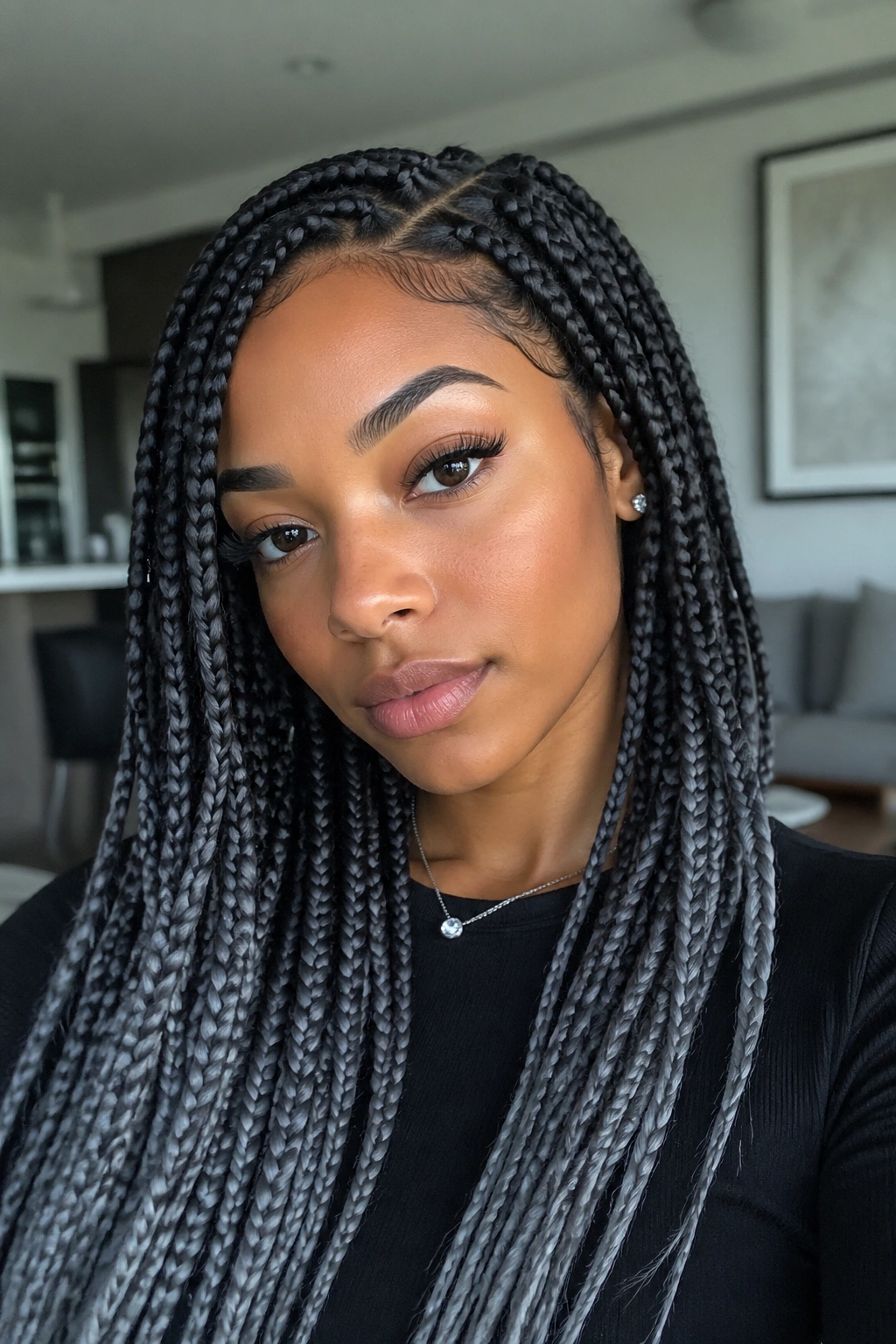 Close-up portrait of a real woman with ash black and steel gray braids.
