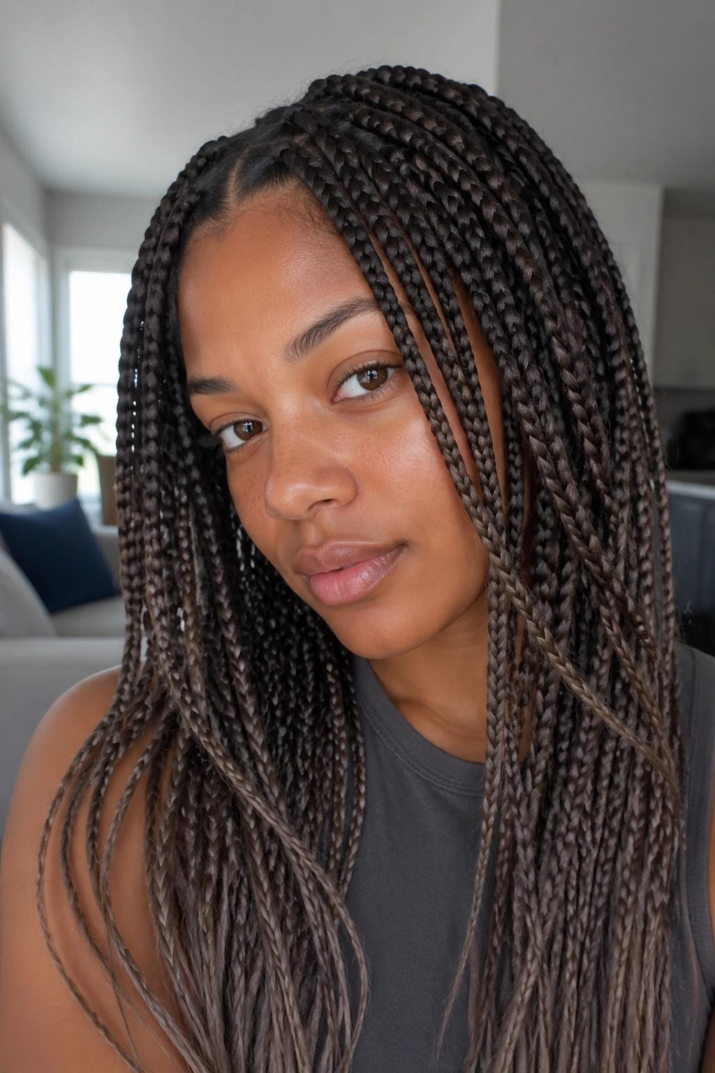Close-up of a real woman with ash brown ombré knotless box braids