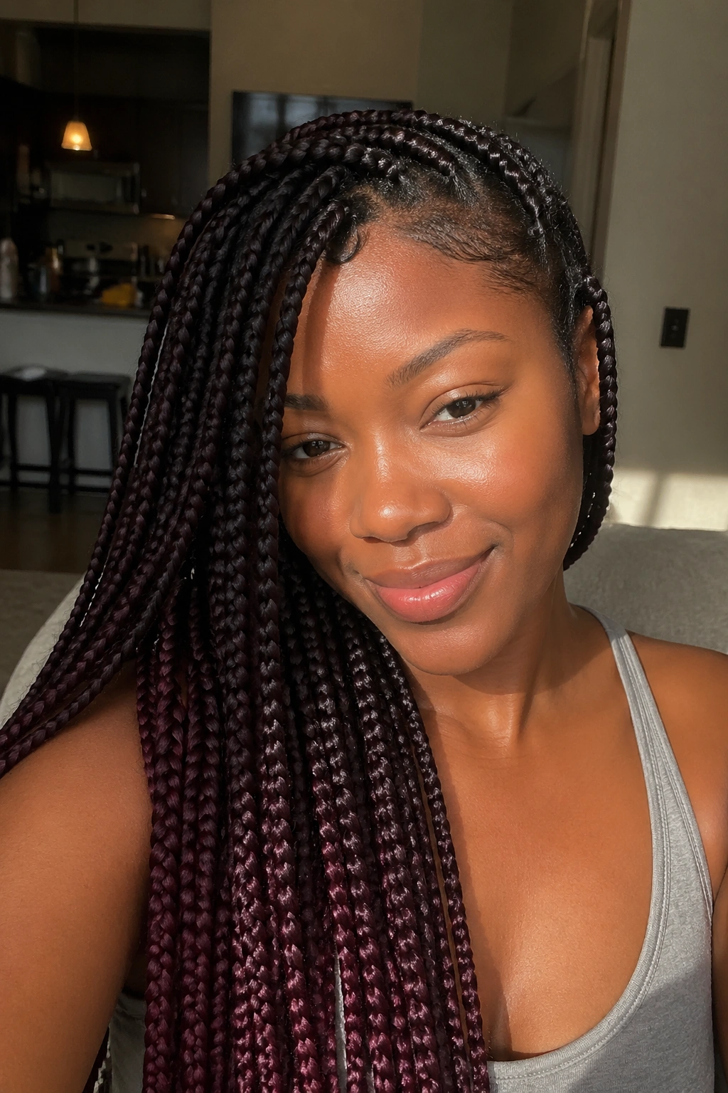 Close-up portrait of a real person with espresso base and plum ends in box braids