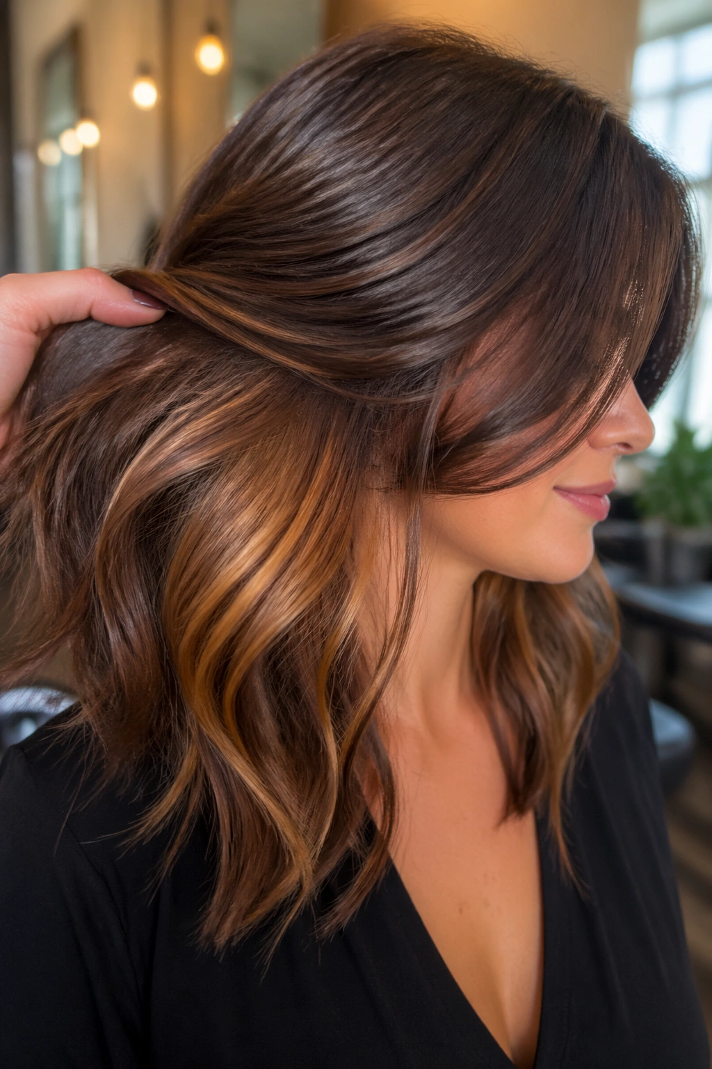 Close-up portrait showing bronze underlights beneath a top brown layer on real hair