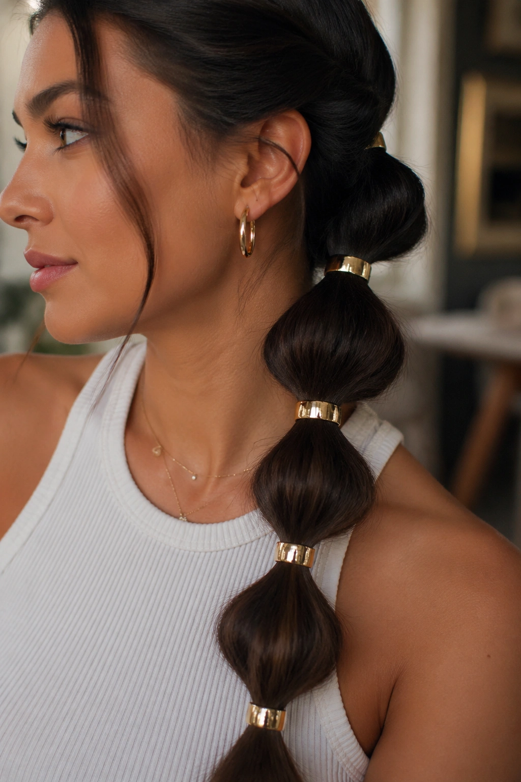 Bubble braid with hair cuffs on a real person in a chic indoor setting