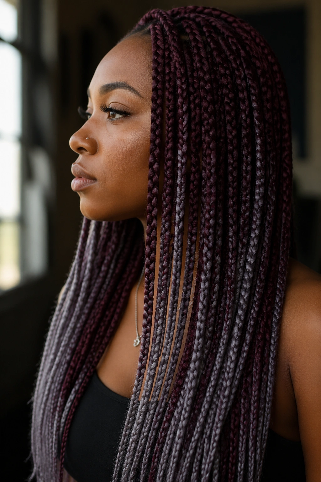 Portrait of a real person with burgundy base hair and cool grey highlights