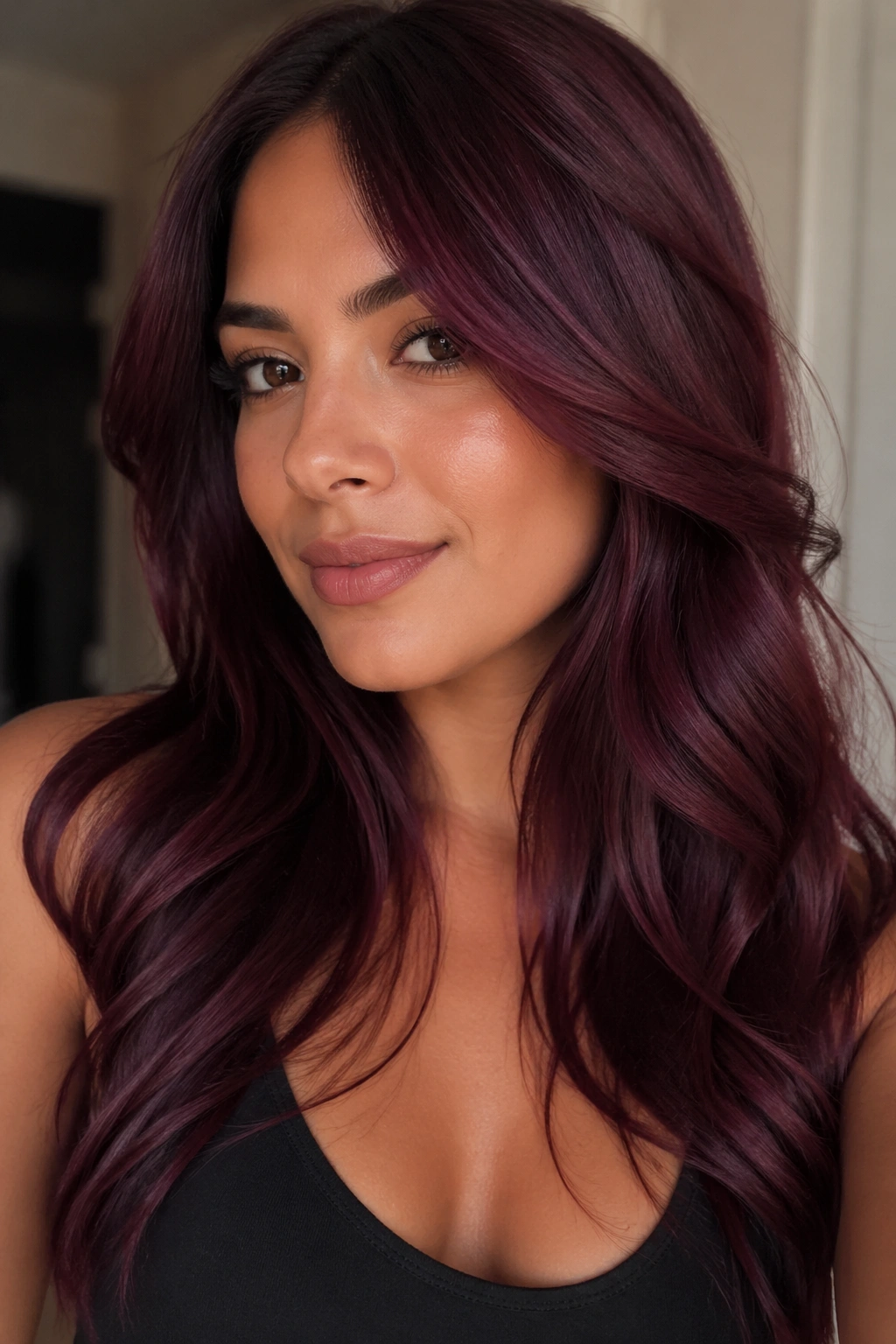Close-up of a woman with burgundy wine hair under daylight