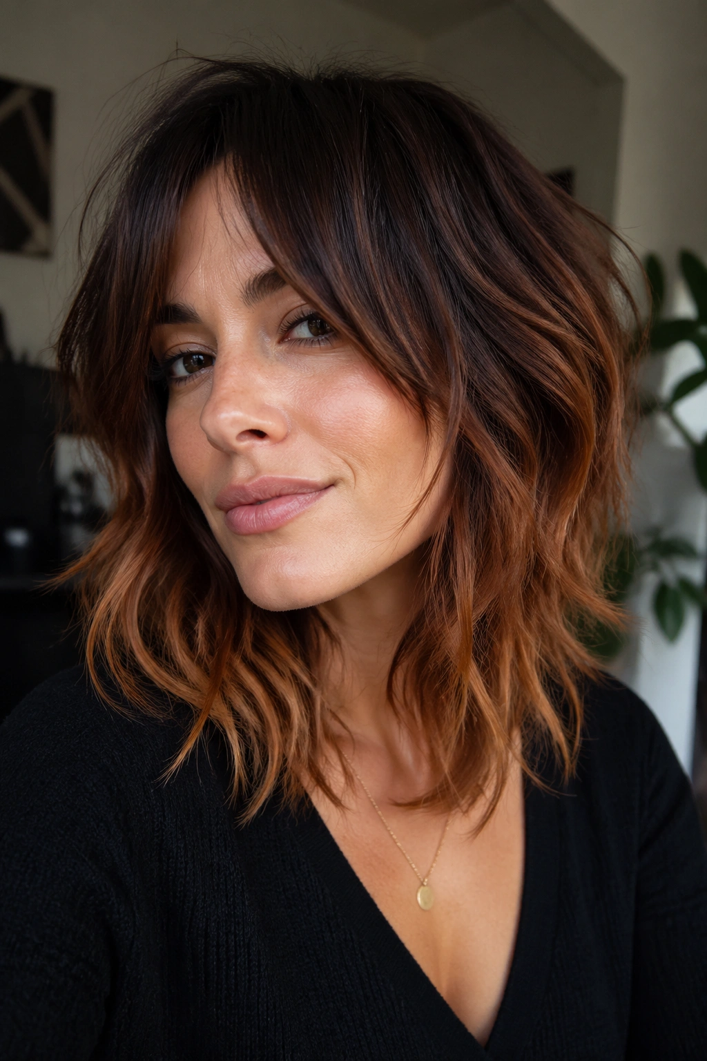 Close-up of real woman with chocolate to copper balayage on a shag hairstyle