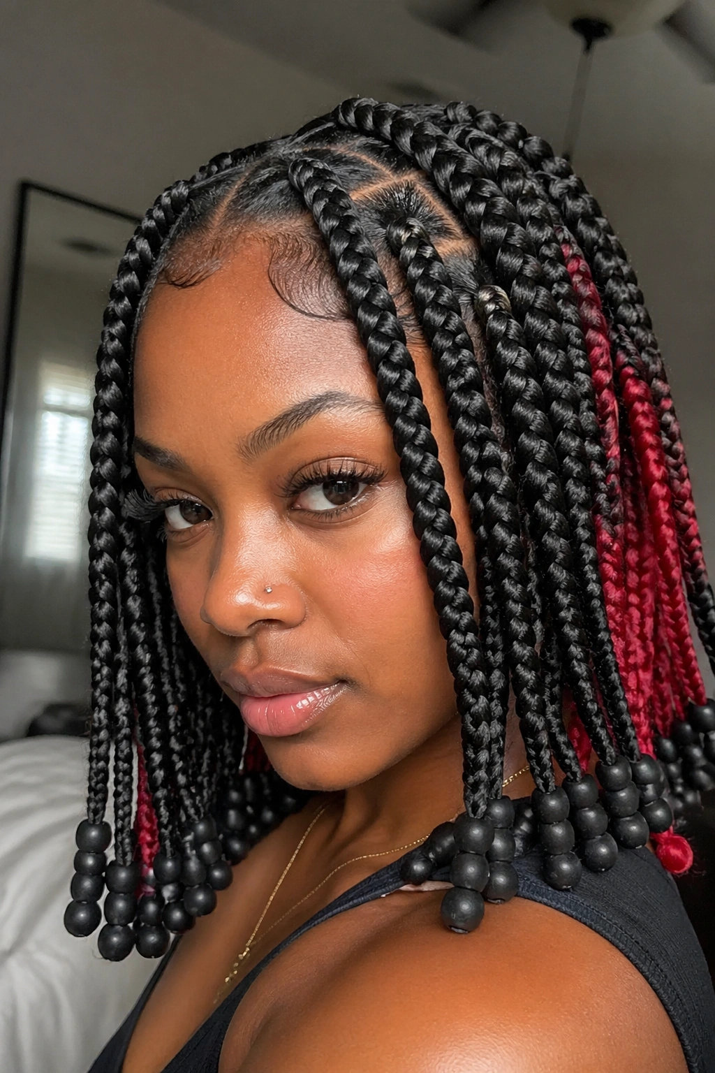 Close-up of chunky front braids with red peekaboo and black beads