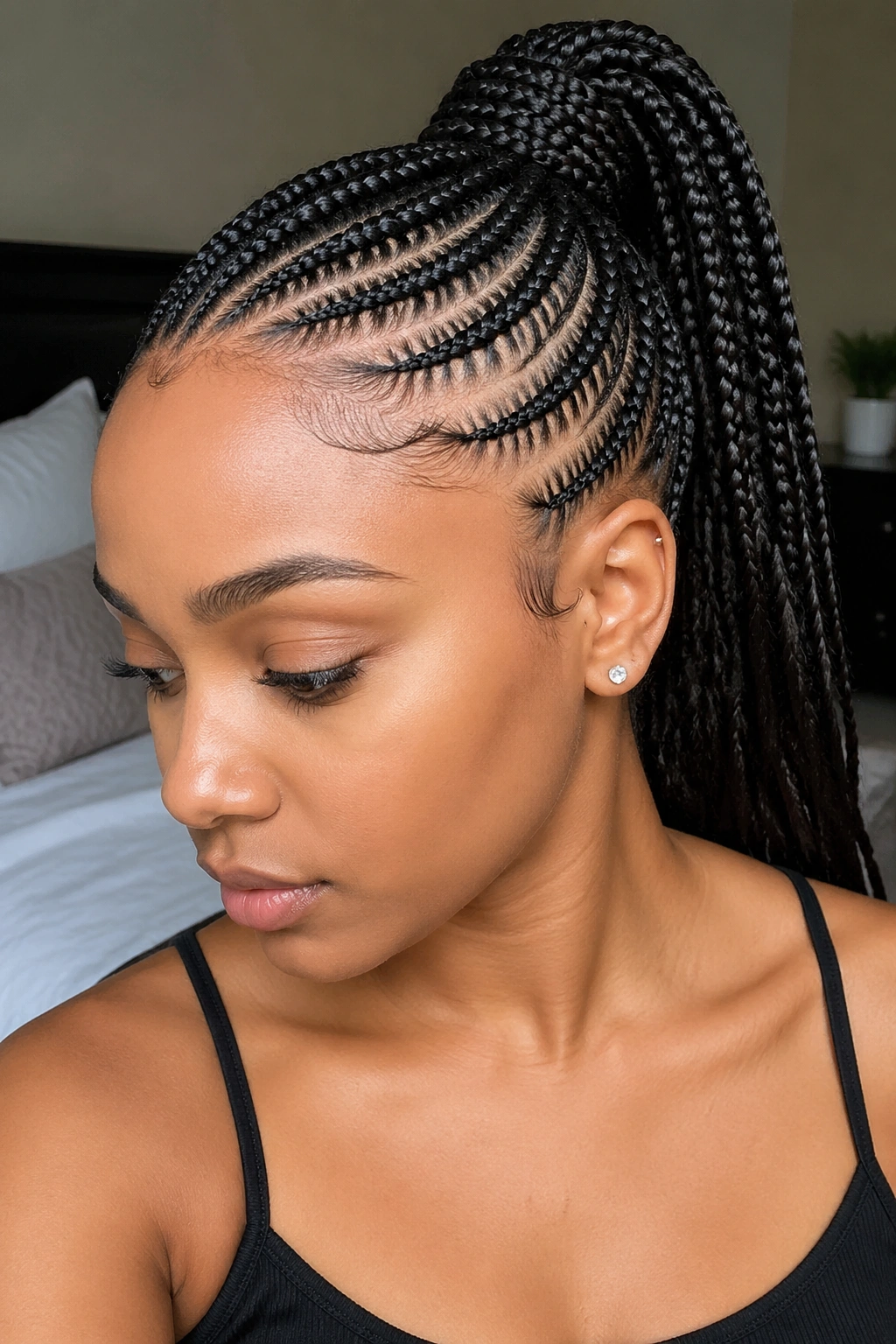 Close-up of a real woman with curved cornrow ponytail following the hairline.