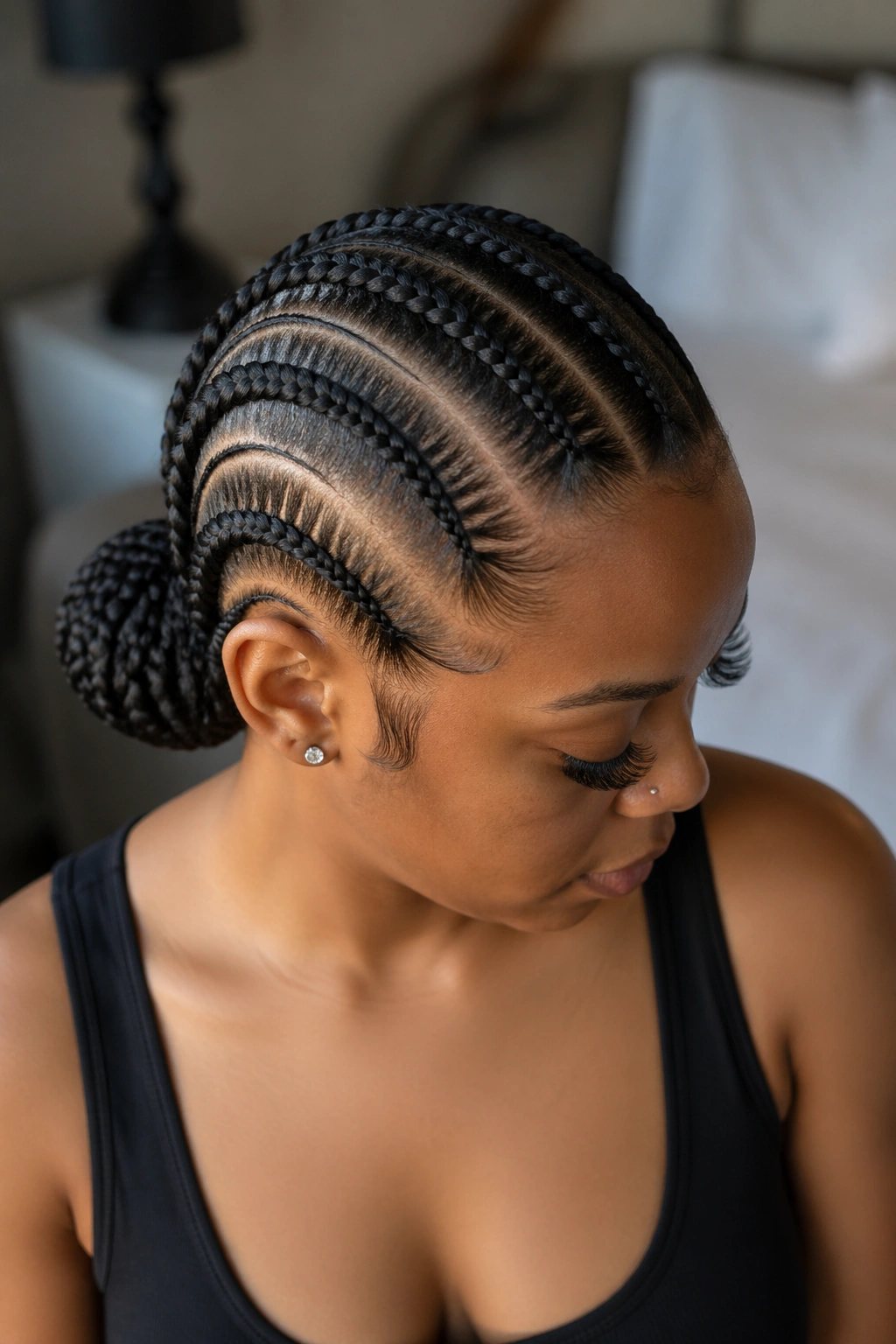 Close-up of a real woman with feed-in cornrows into a low bun