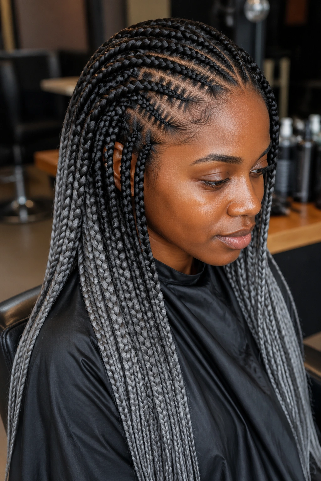 Close-up of a real person with feed-in grey box braids starting at the scalp
