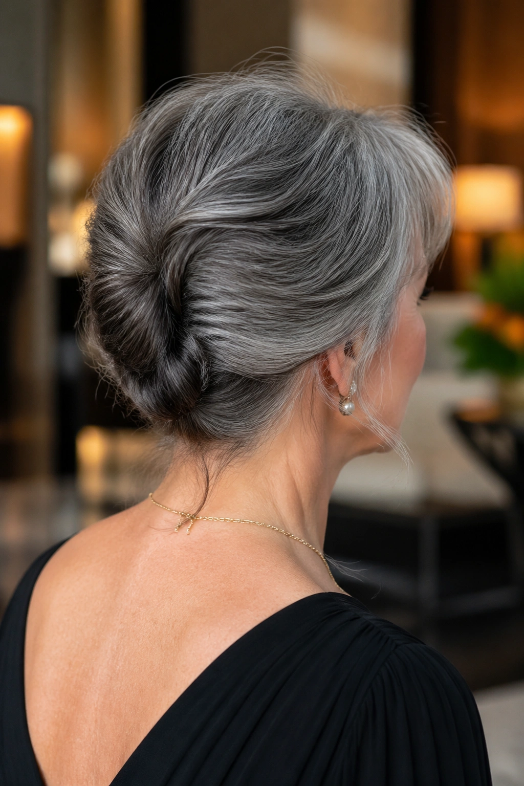 Real woman wearing a relaxed French twist hairstyle.