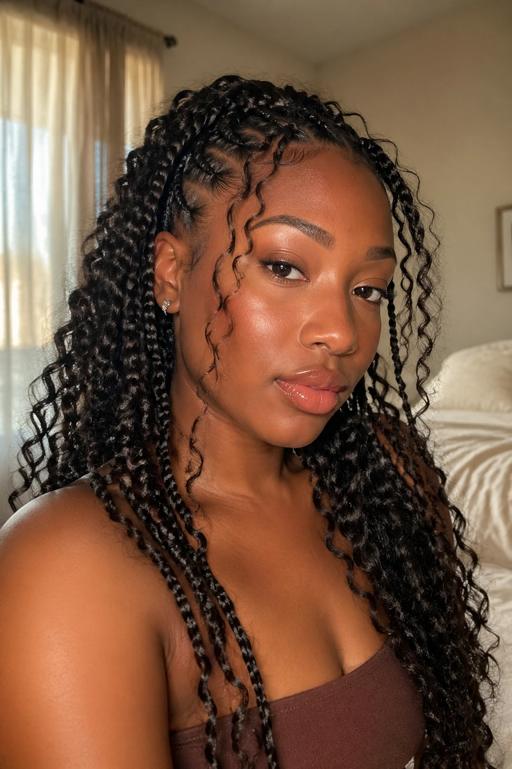 Close-up portrait of a real woman with Goddess butterfly braids and loose curls