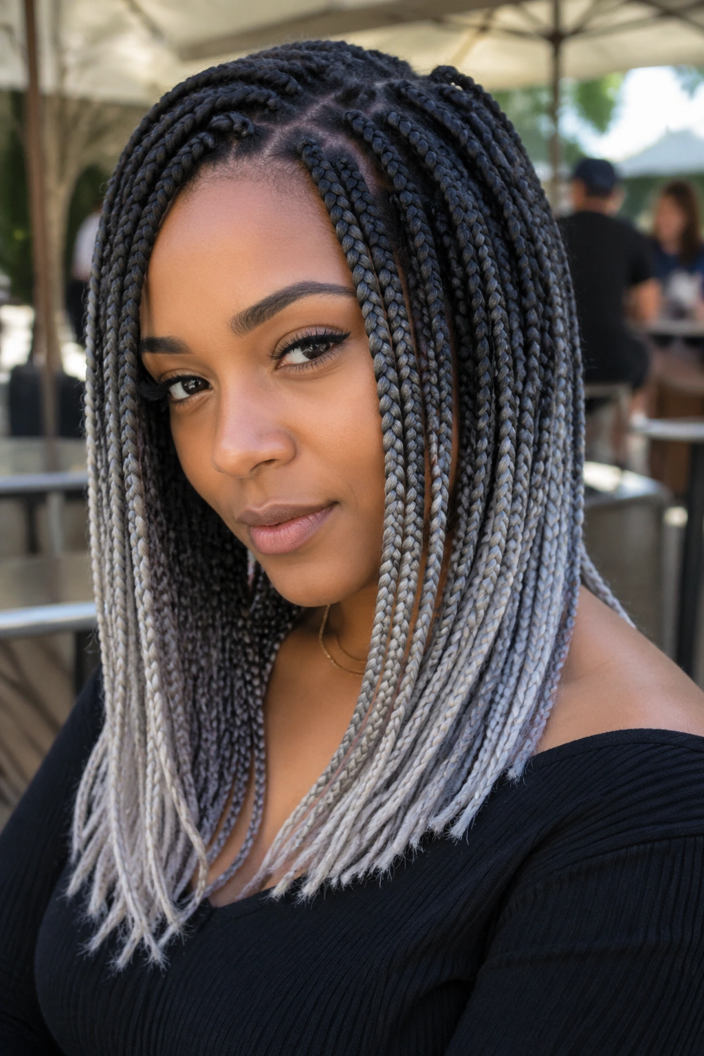Close-up of smoky ombré grey box braids outdoors in soft daylight