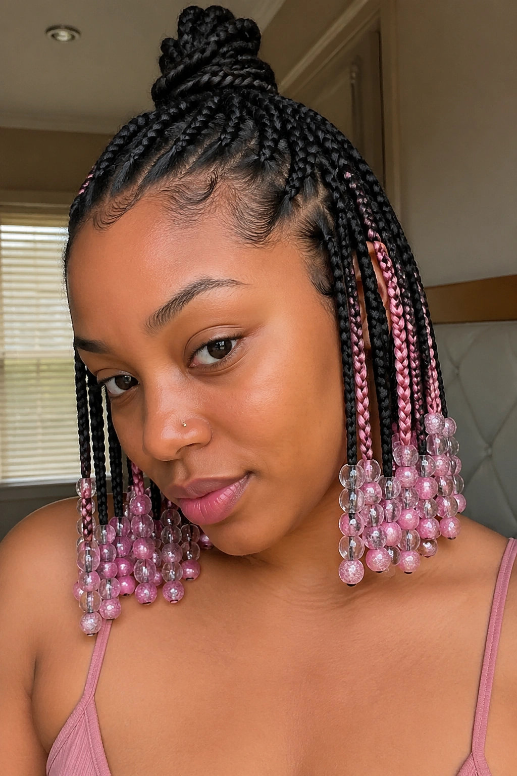 Close-up of half-up knotless braids with pink peekaboo and mixed beads