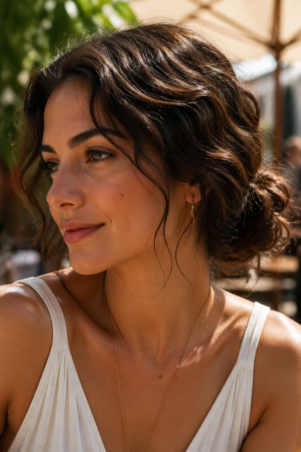 Close-up of a real woman in a low messy bun with a halo of loose waves