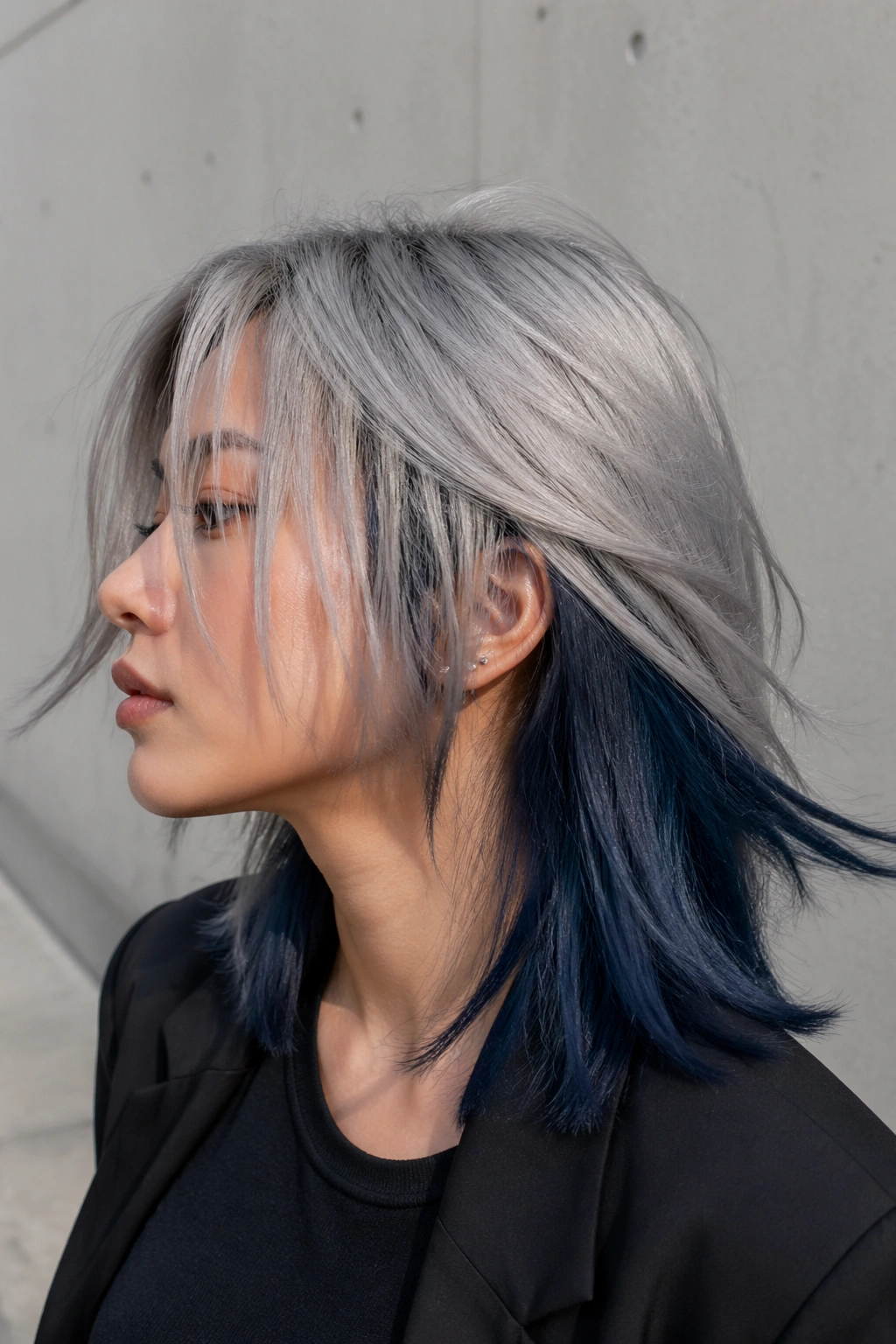 Close-up of hair with silver top layer and midnight blue underlayer on a real person