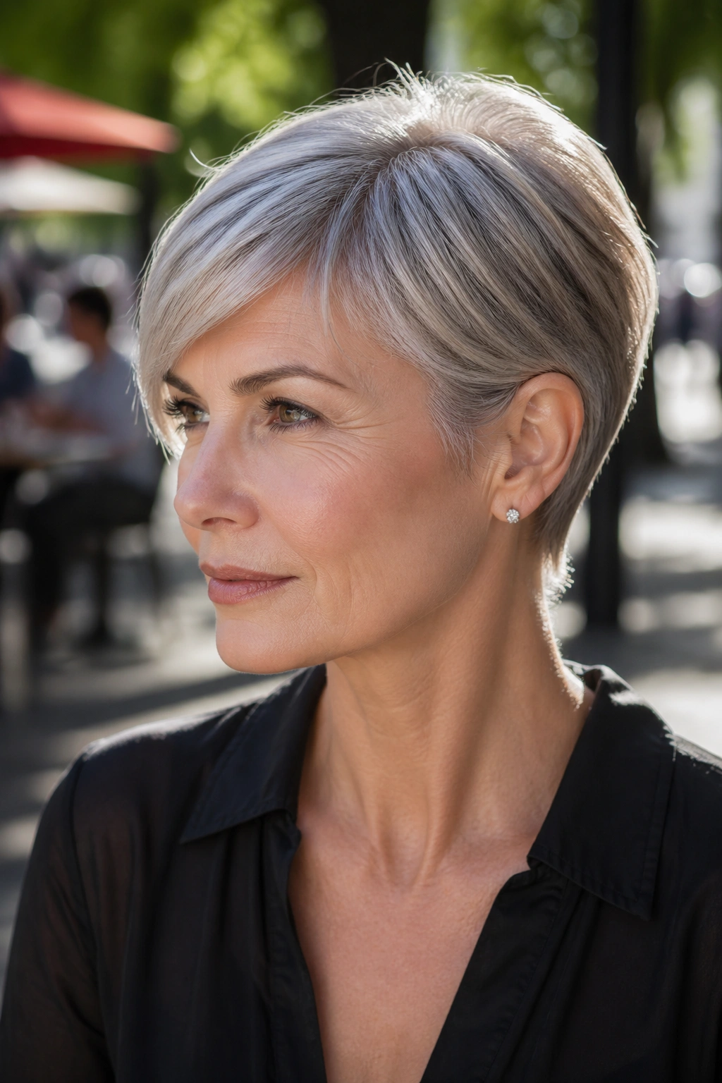 Close-up portrait of a real woman with ear-tucked pixie and longer sides