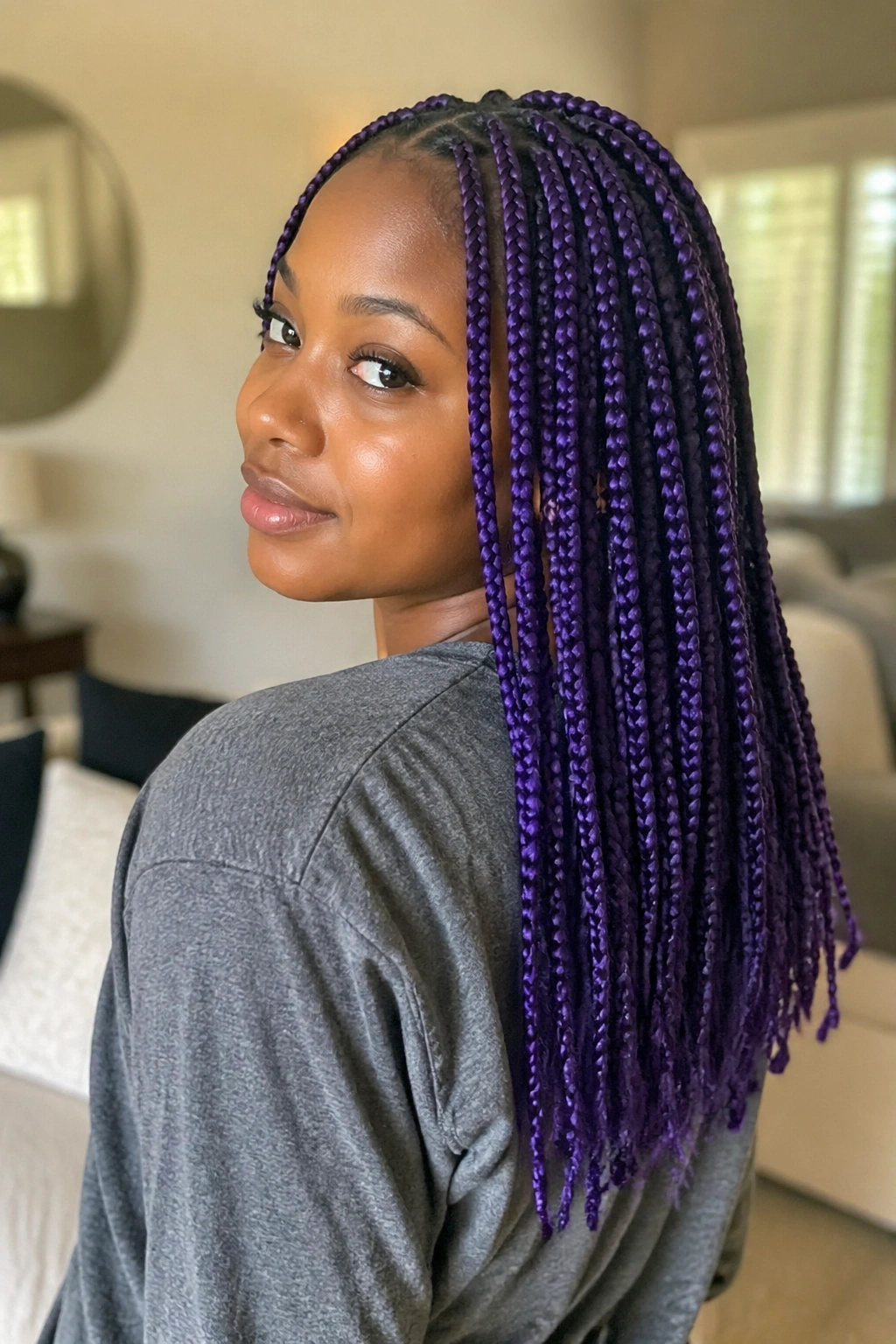 Close-up of a real person with 18-inch purple knotless box braids filling the frame