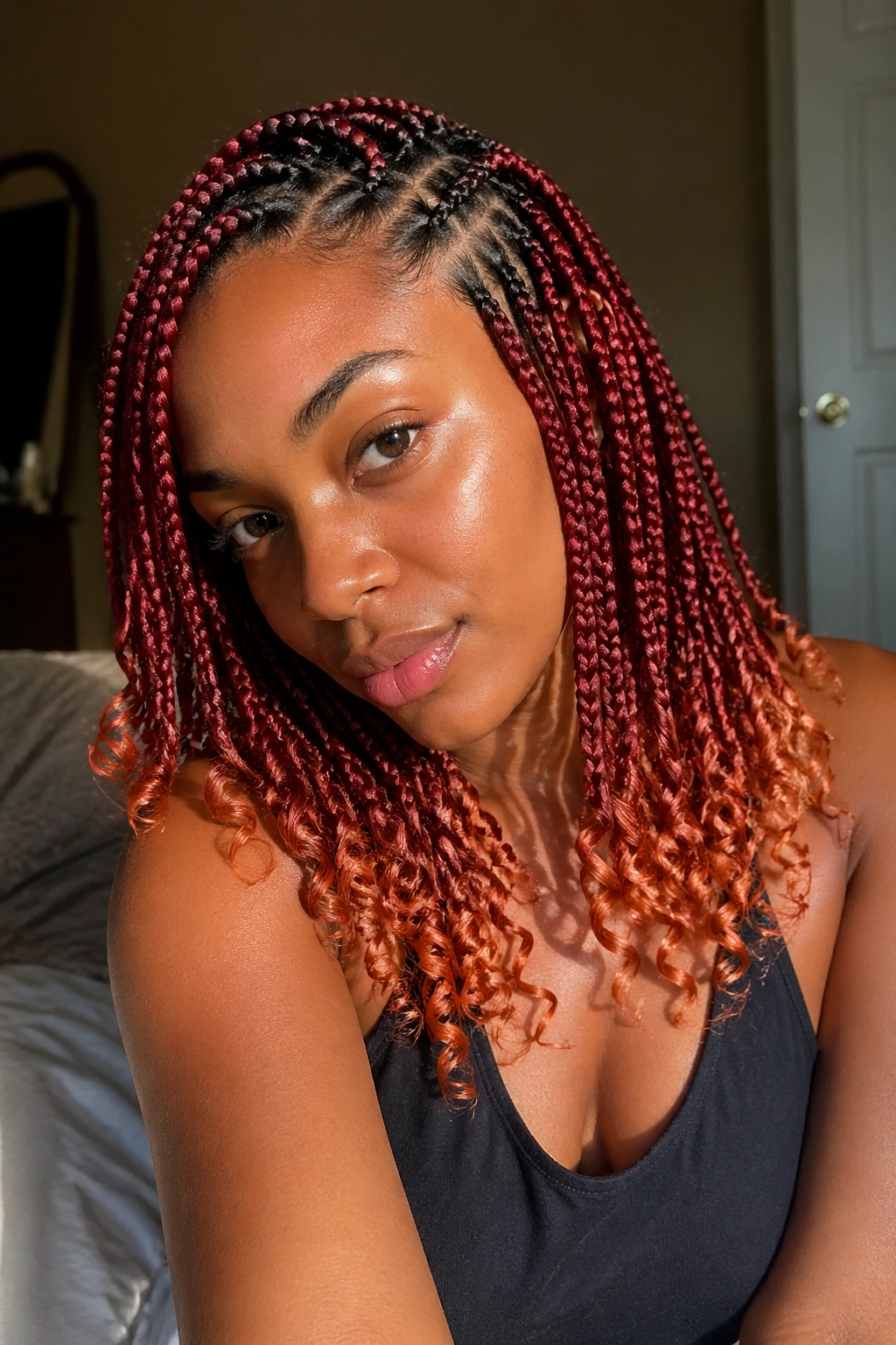 Close-up portrait of a real woman with copper-ended knotless box braids
