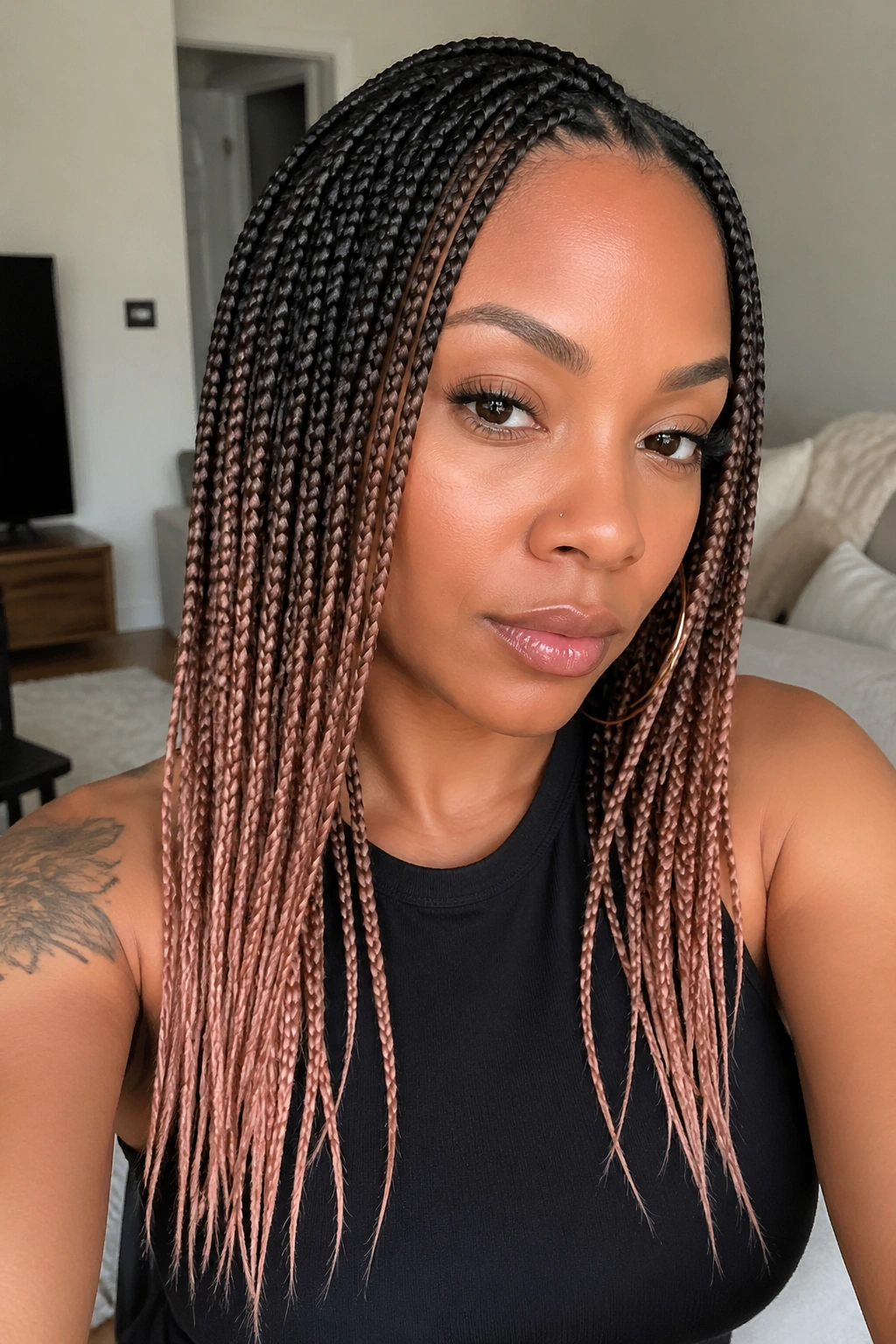 Close-up of small knotless braids with rose-gold ends on a real woman