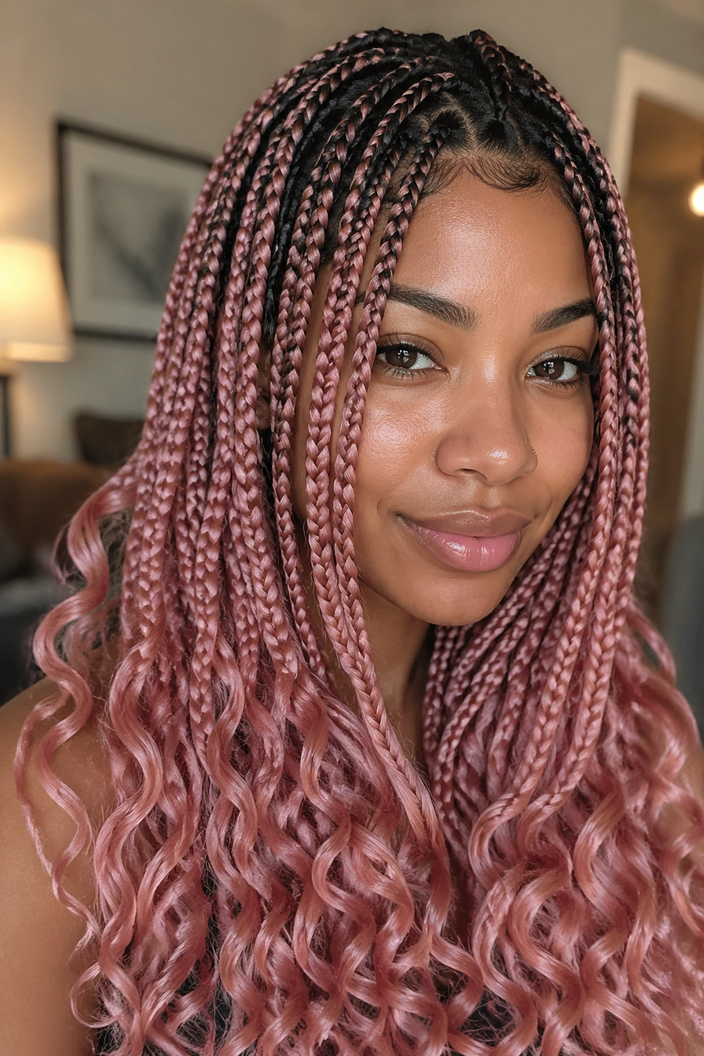 Close-up portrait of a real woman with rose-gold pink knotless braids and dark roots