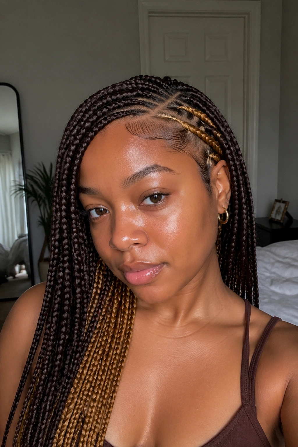 Real person with side-part braids and hidden golden-brown swirls.