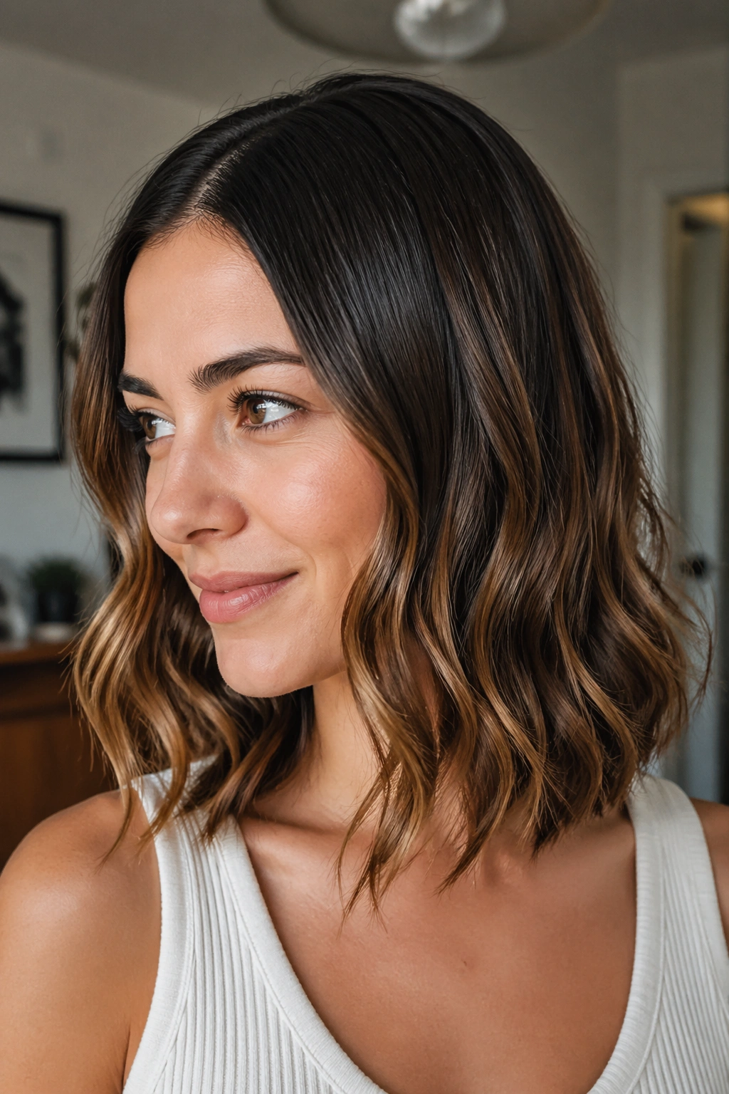 Portrait of a real person showing sleek roots with wavy ends hairstyle