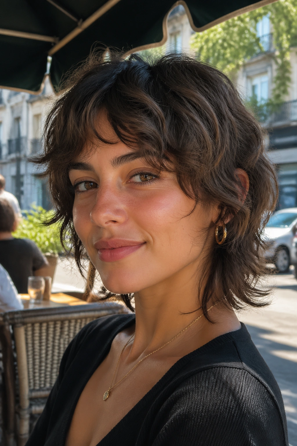 Close-up portrait of a real person with a soft wolf cut on short wavy hair