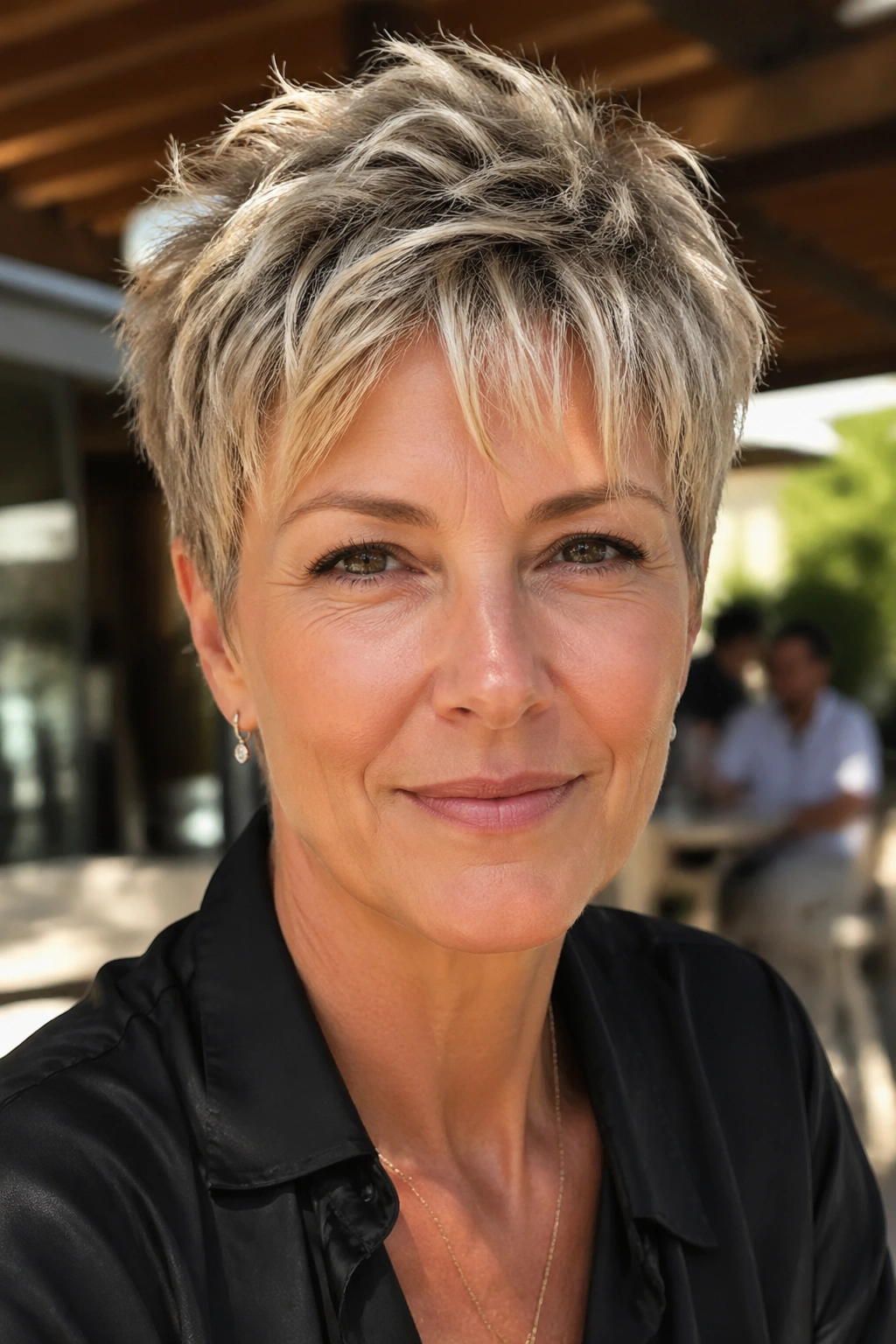 Portrait of a real woman with a short textured crop showing movement on top.