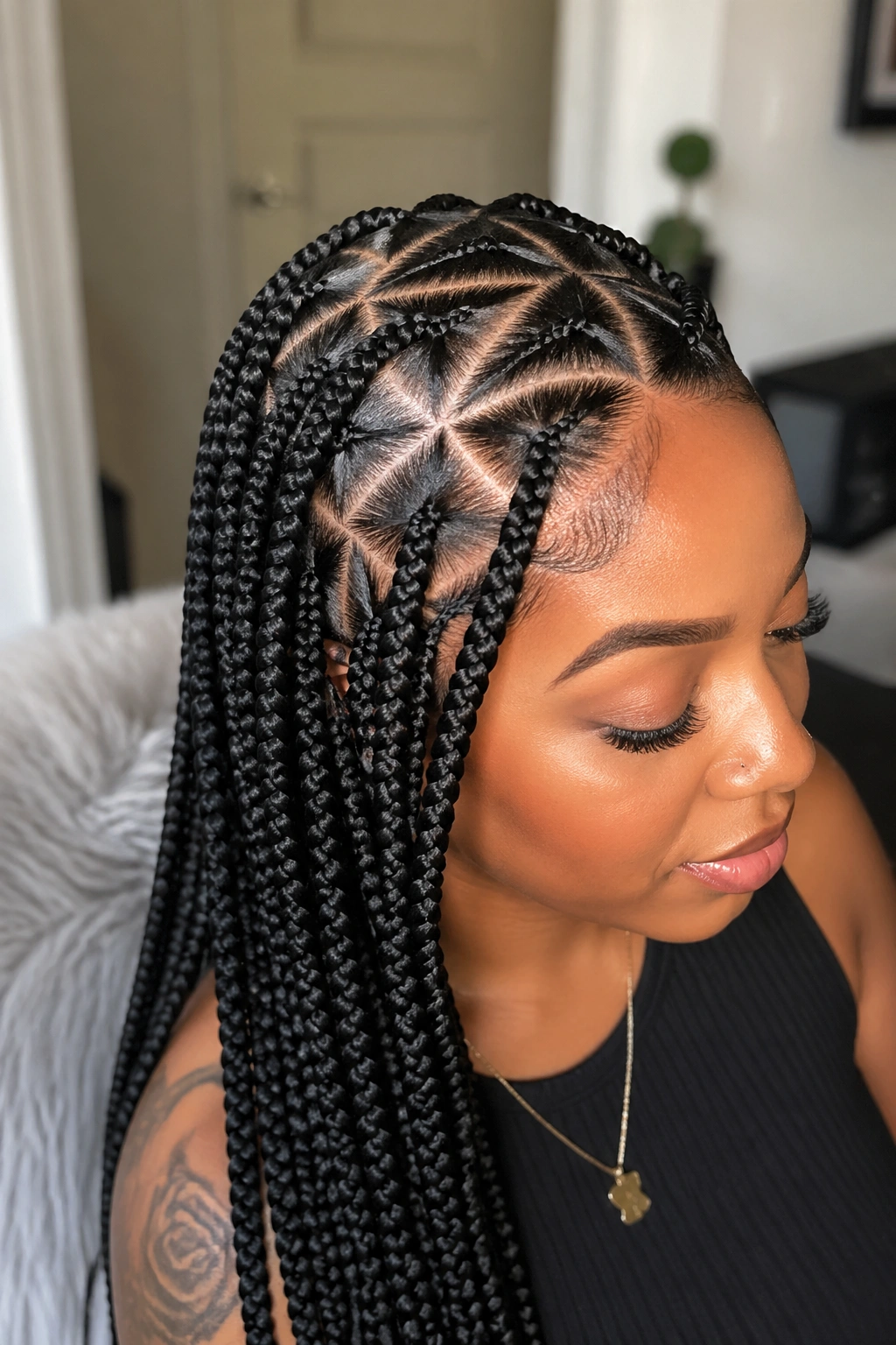 Real person with triangle-parted box braids showing geometric parts.