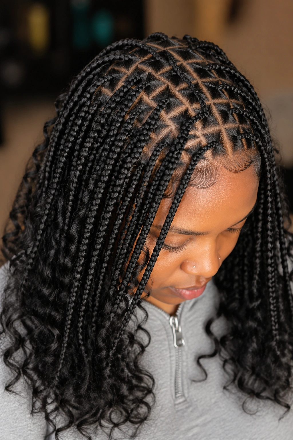 Real woman with triangle-part knotless braids and curly ends