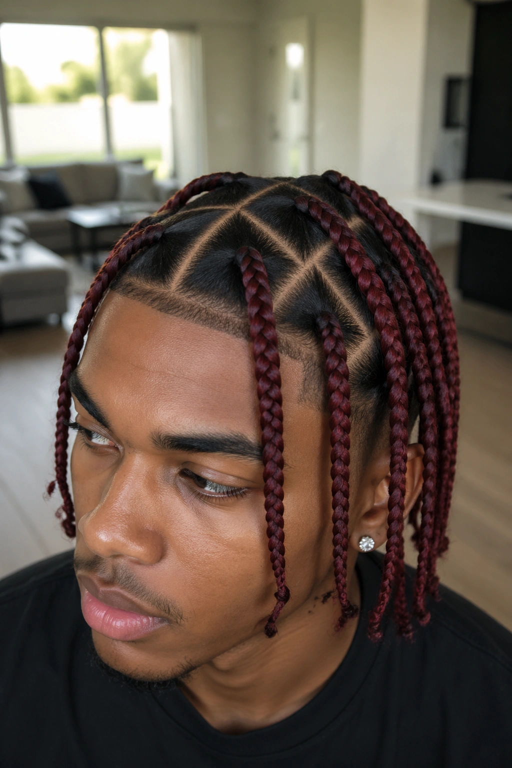 Real person with crimson triangle-part braids in bright room