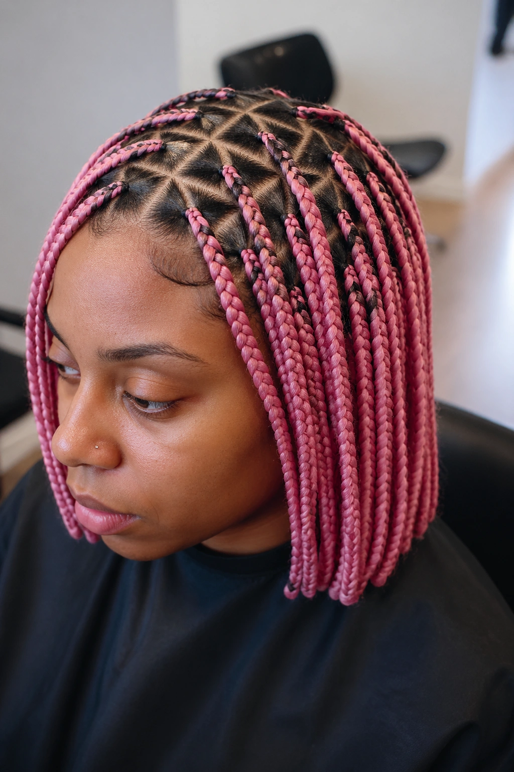 Real woman with triangle-part pink braids showing crisp scalp lines