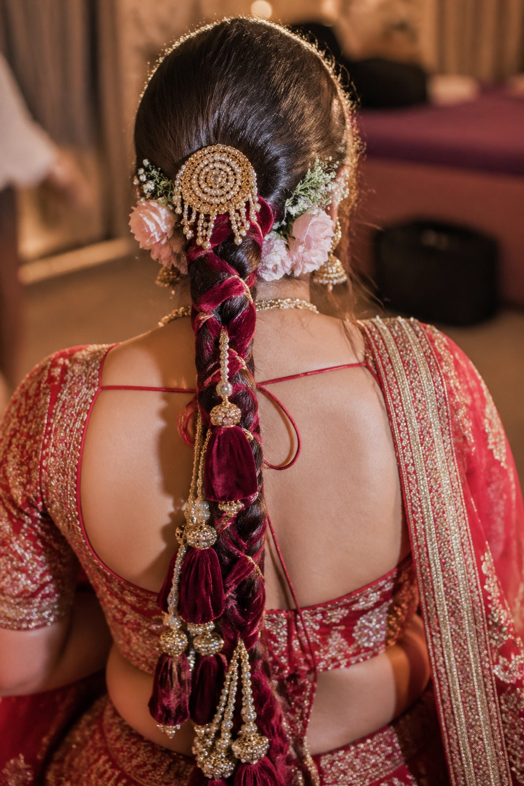 Close-up of a bride's velvet parandi braided into a dense, rich braid