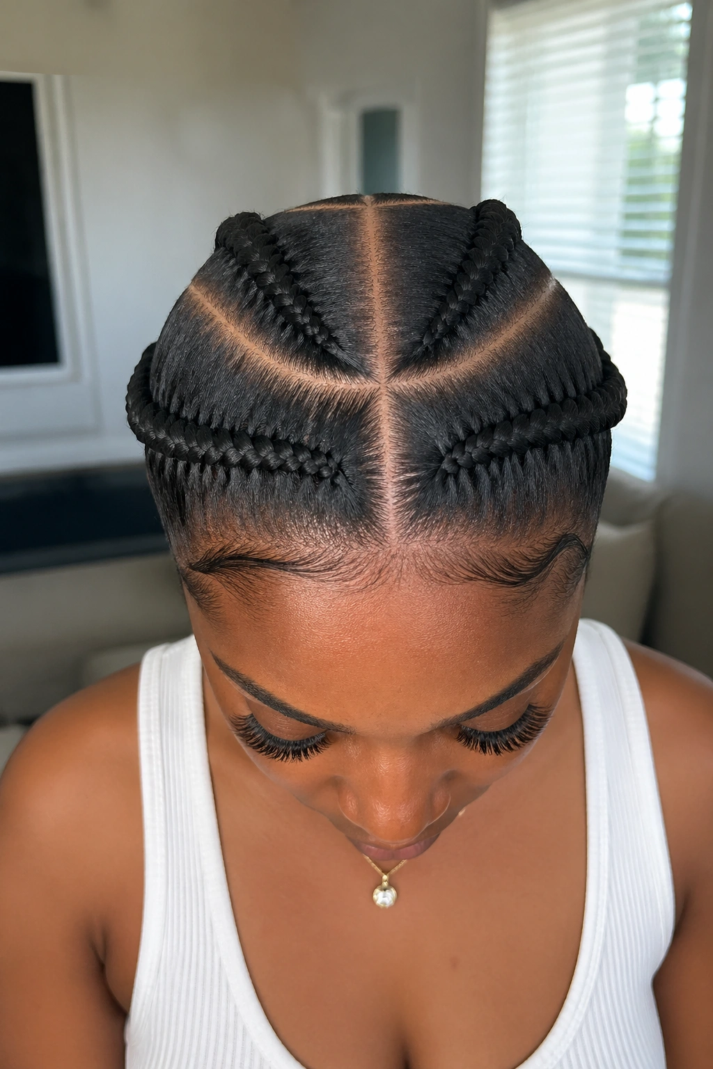 Close-up of a real person with four-section Vixen braids on the crown