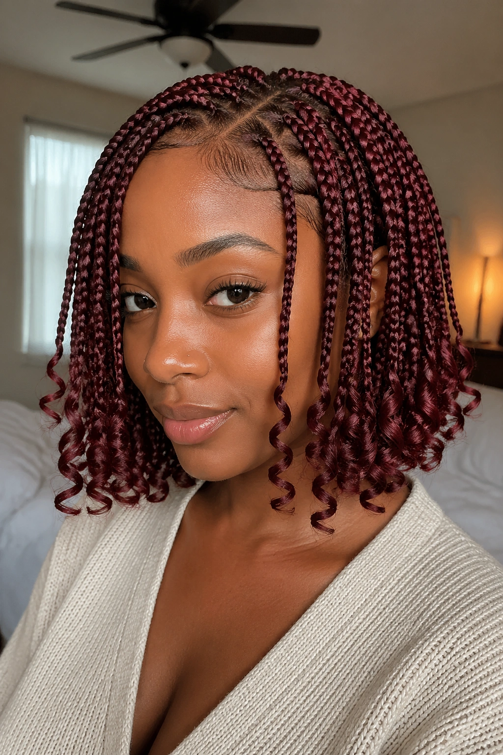 Close-up of a real woman with wine-red bob-length knotless braids