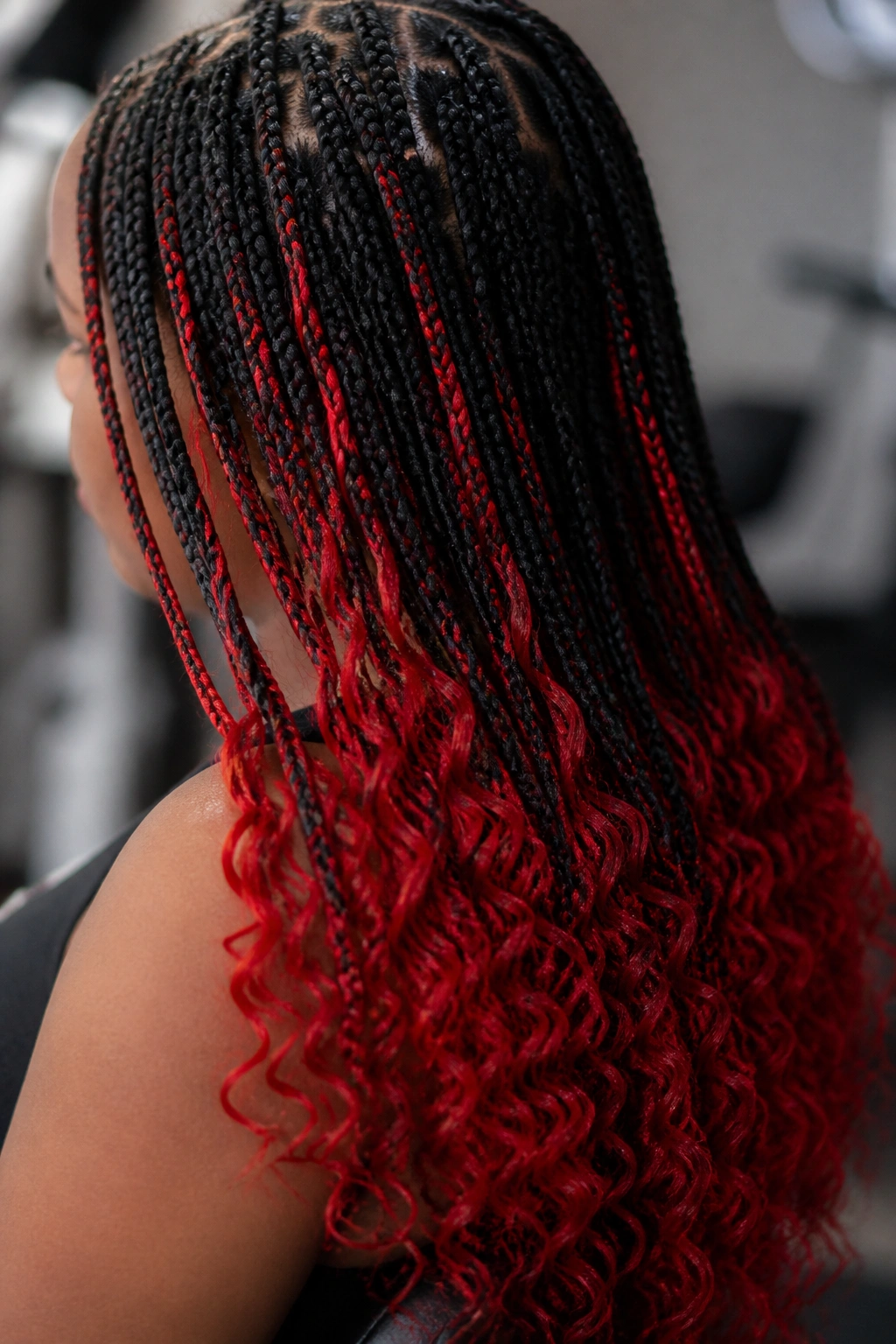 Close-up of lower-half braids showing bright cherry red highlights